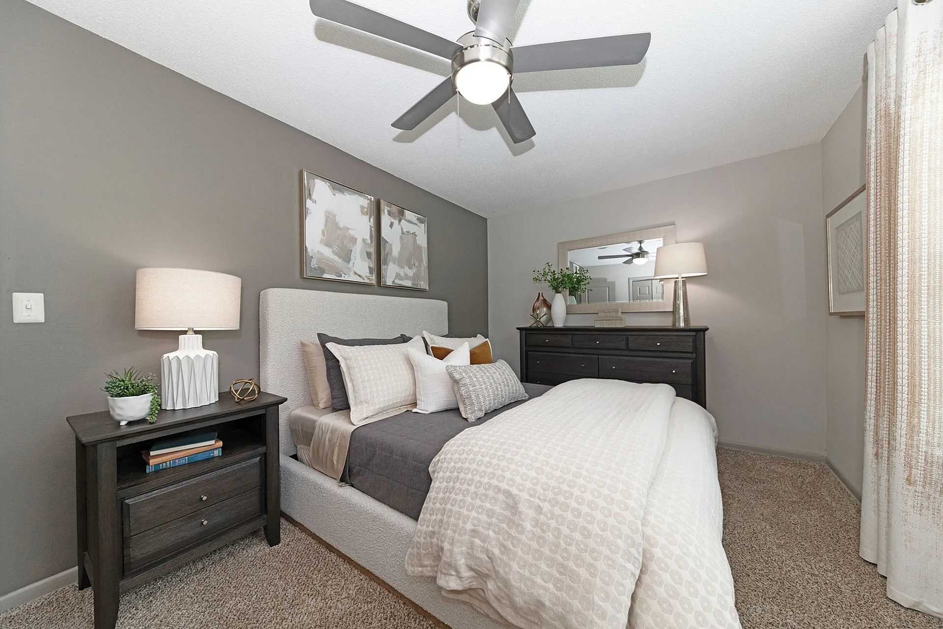 Elegant bedroom with stylish decor, featuring a plush bed with cozy pillows, modern nightstands, and tasteful wall art.