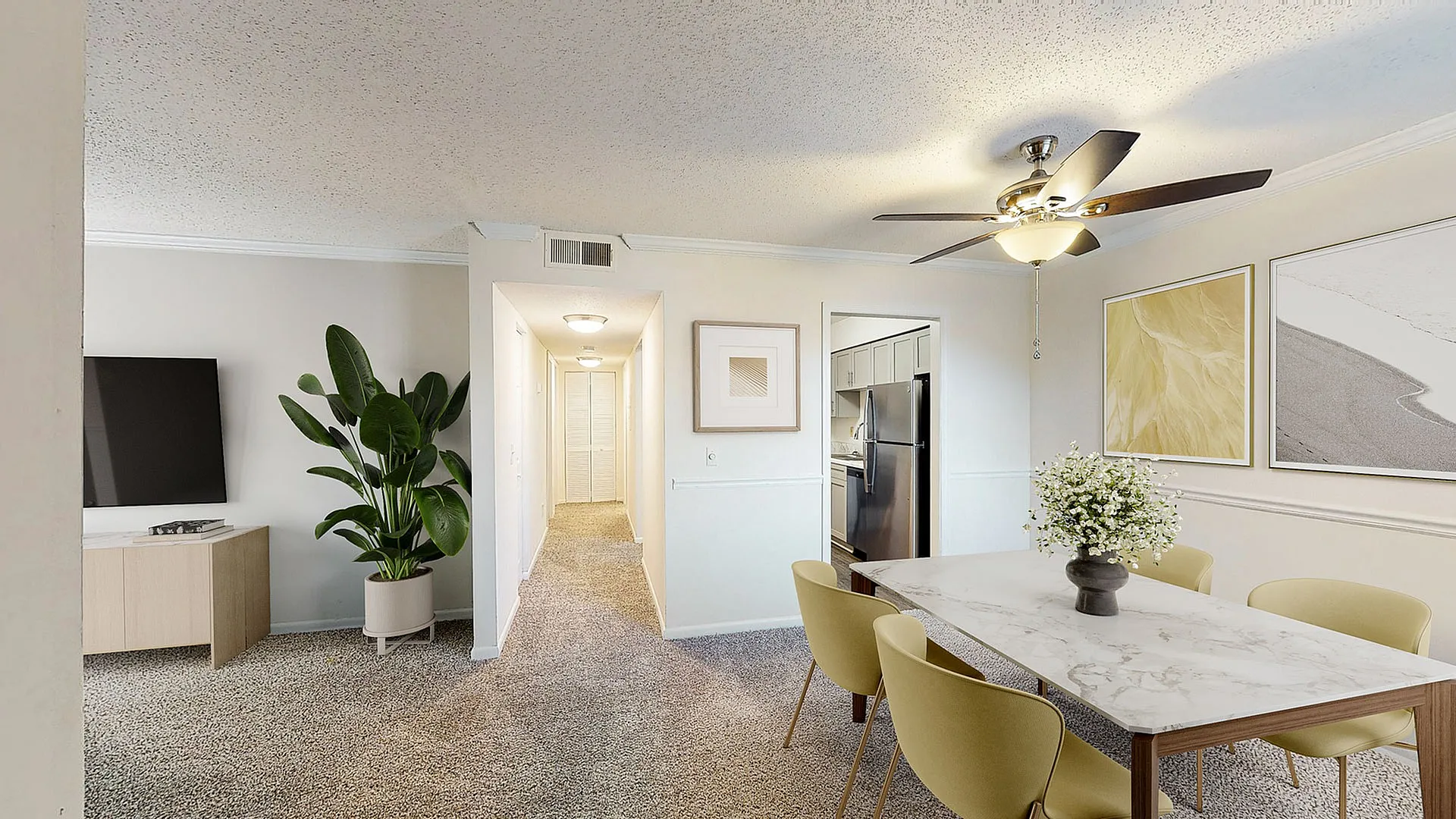 Inviting dining area in modern apartment with elegant decor, featuring a marble table, chic yellow chairs, and stylish wall art.