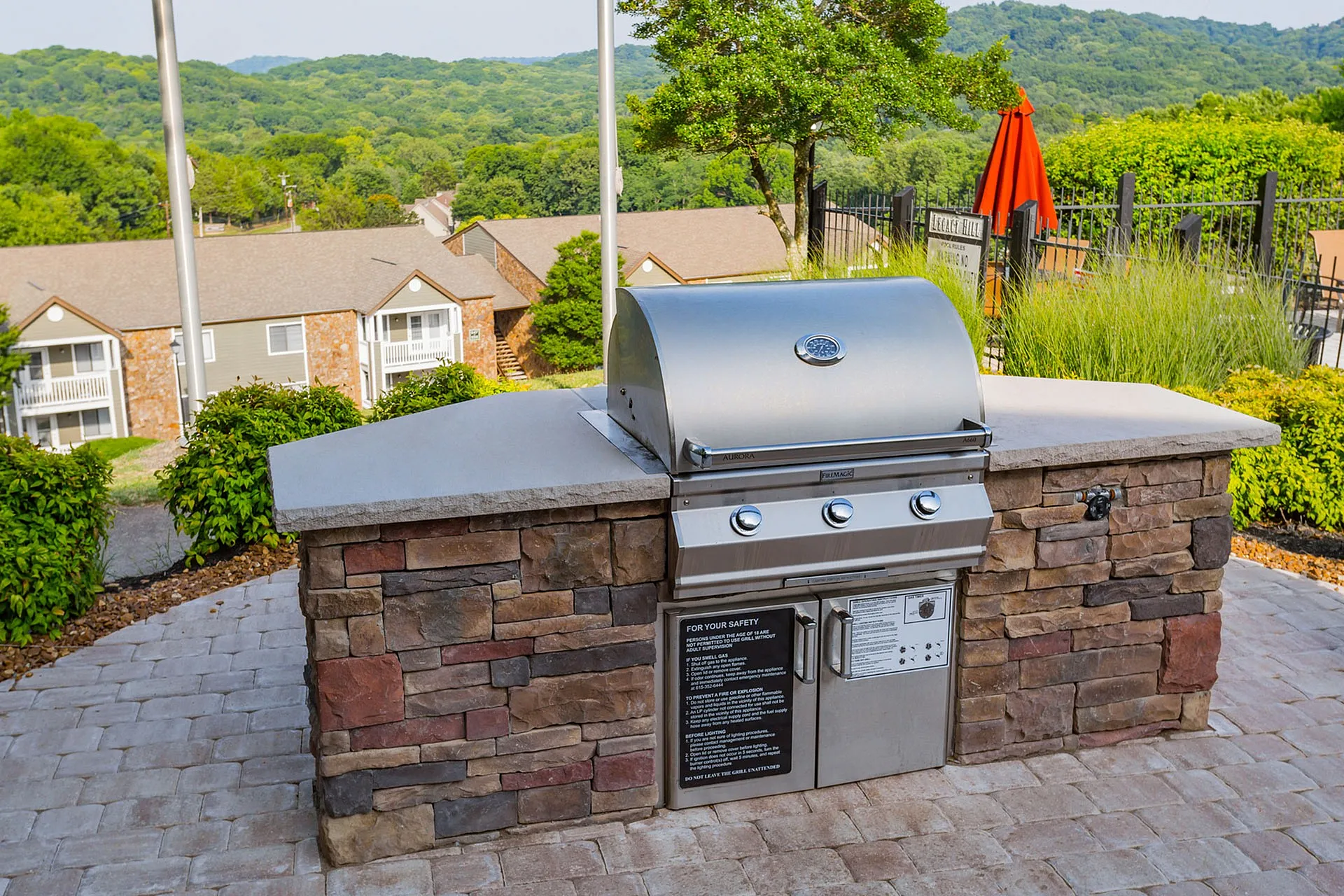 Charming outdoor grill area with stainless steel barbecue and scenic mountain views, ideal for entertaining.