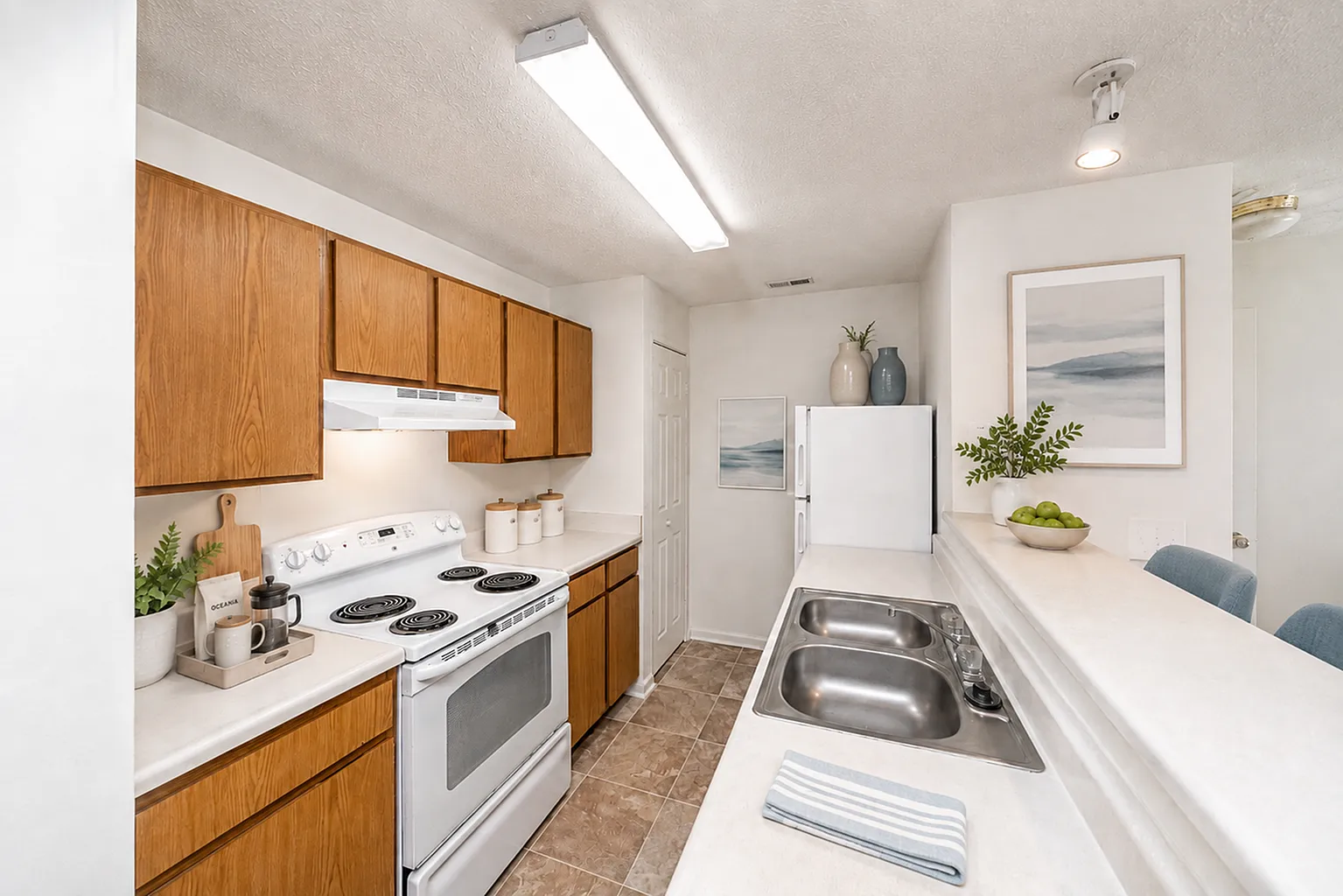 Charming kitchen with warm wooden cabinets, modern appliances, and a sleek dual sink, boasting a cozy and inviting ambiance.