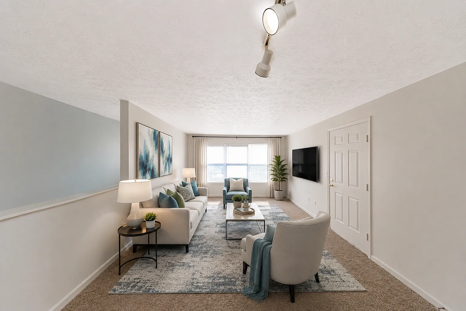 Bright and inviting living room with modern decor, featuring cozy seating, elegant lighting, and abundant natural light from large windows.