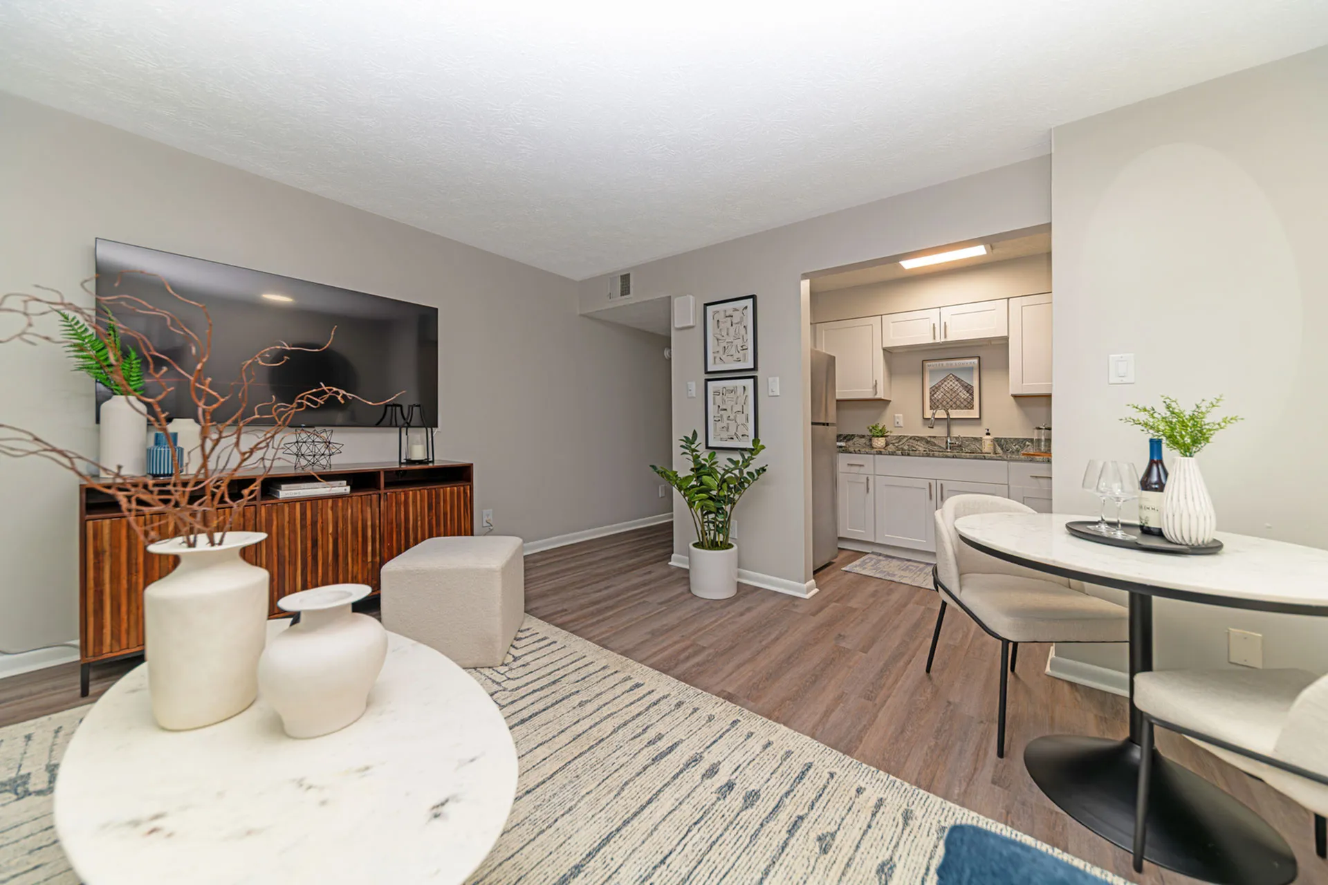 Inviting open-concept living room with modern decor, elegant furniture, and stylish kitchen, perfect for entertaining.