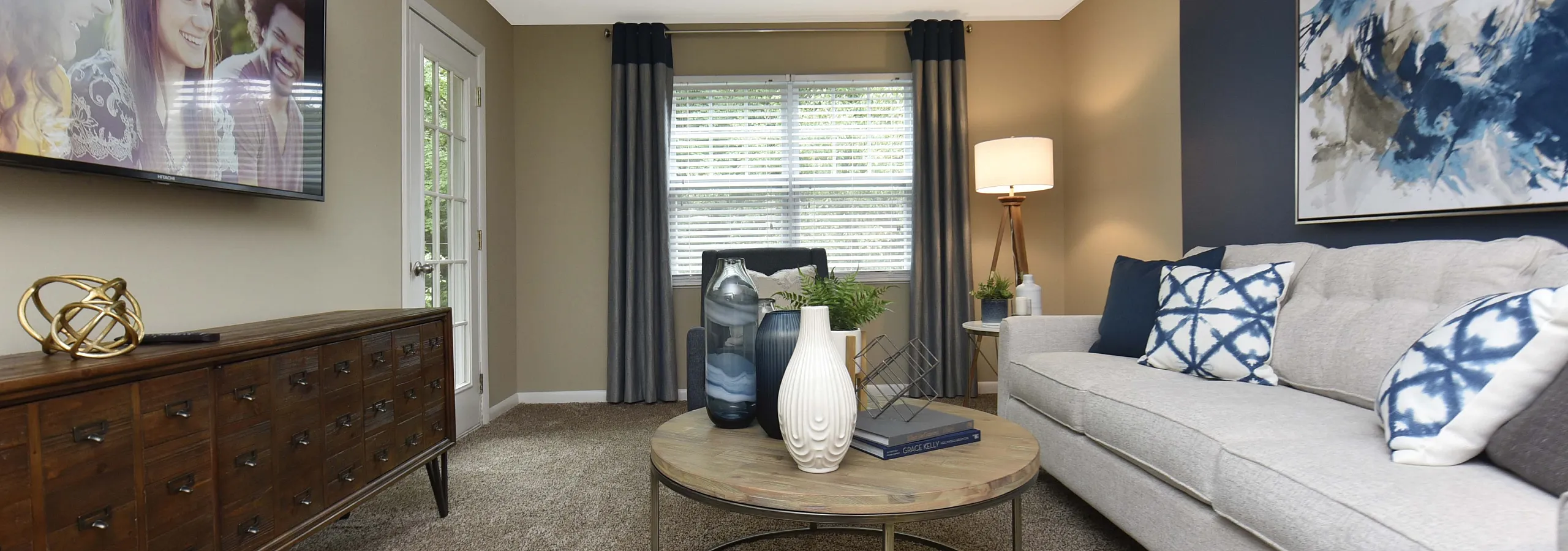 Chic living room with modern decor, featuring a plush sofa, abstract wall art, and a stylish coffee table.