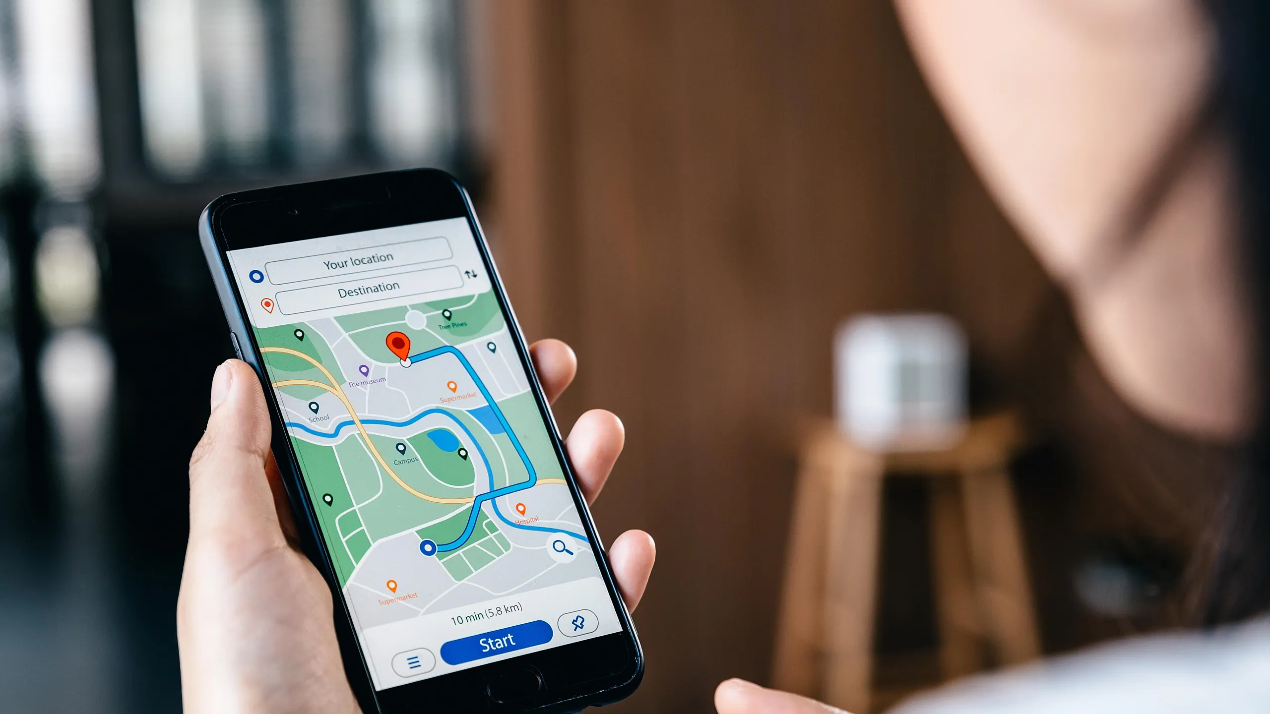 Person using smartphone with navigation app showing a clear path and destinations mapped out.