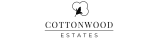 Elegant Cottonwood Estates logo featuring a stylized cotton plant design.