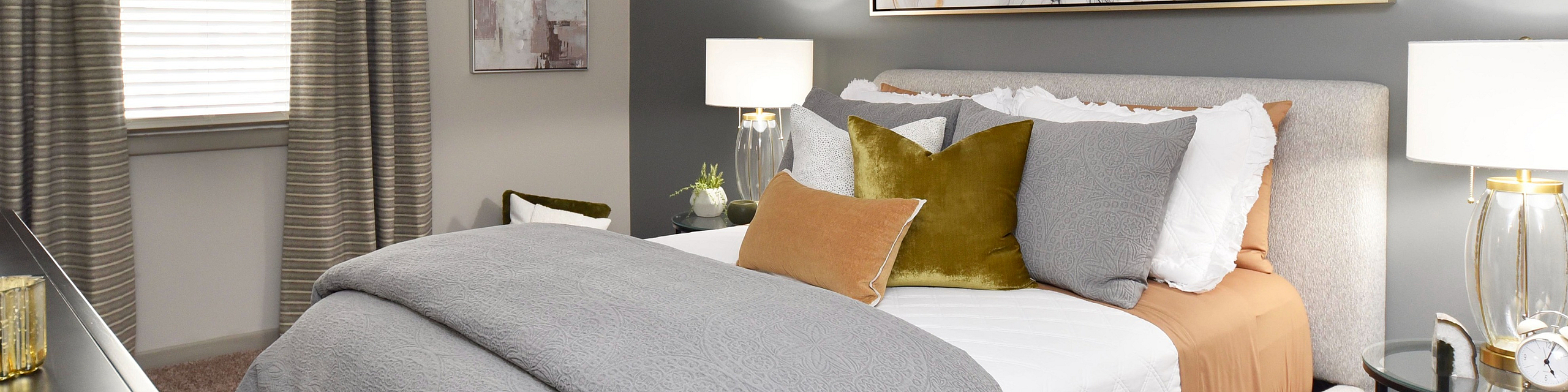 Luxurious bedroom showcasing elegant decor, plush pillows, a stylish artwork, and ambient lighting for ultimate relaxation.