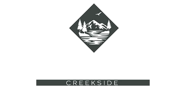 Elegant Arcadia Creekside logo featuring a serene mountain scene with pine trees and birds, embodying tranquility and nature.