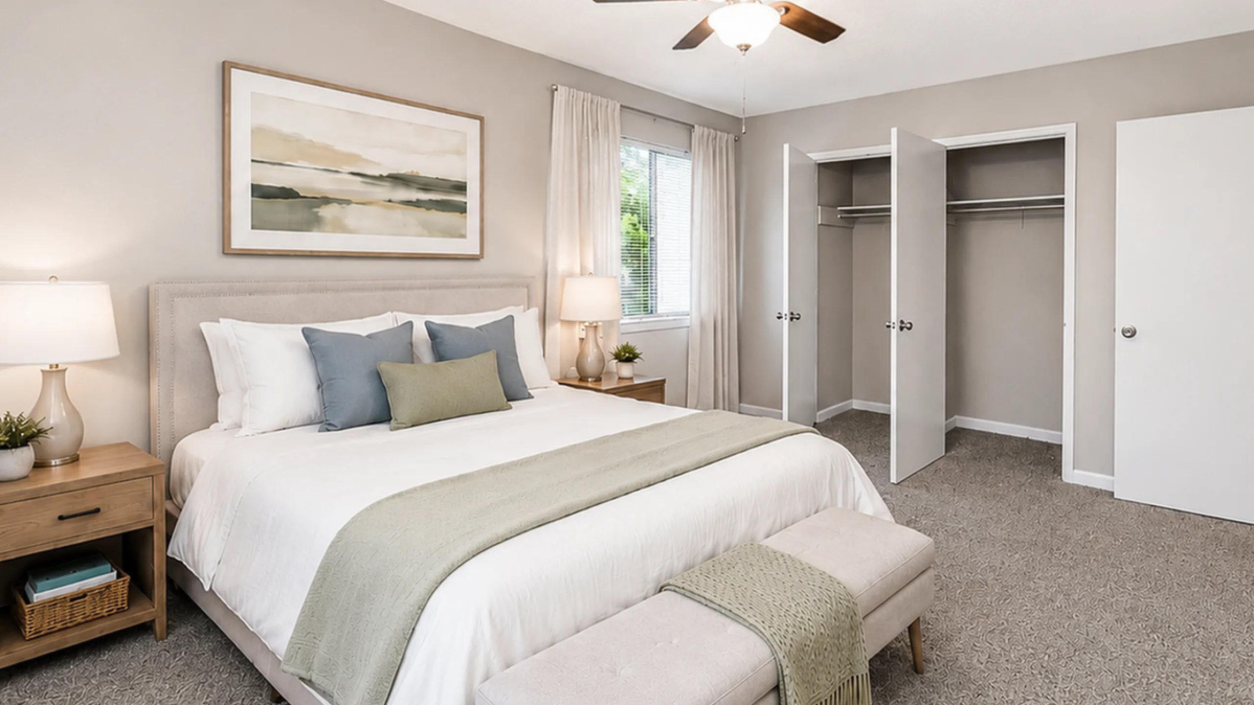 Elegant bedroom with plush queen bed, stylish decor, and ample closet space, perfect for comfort and relaxation.