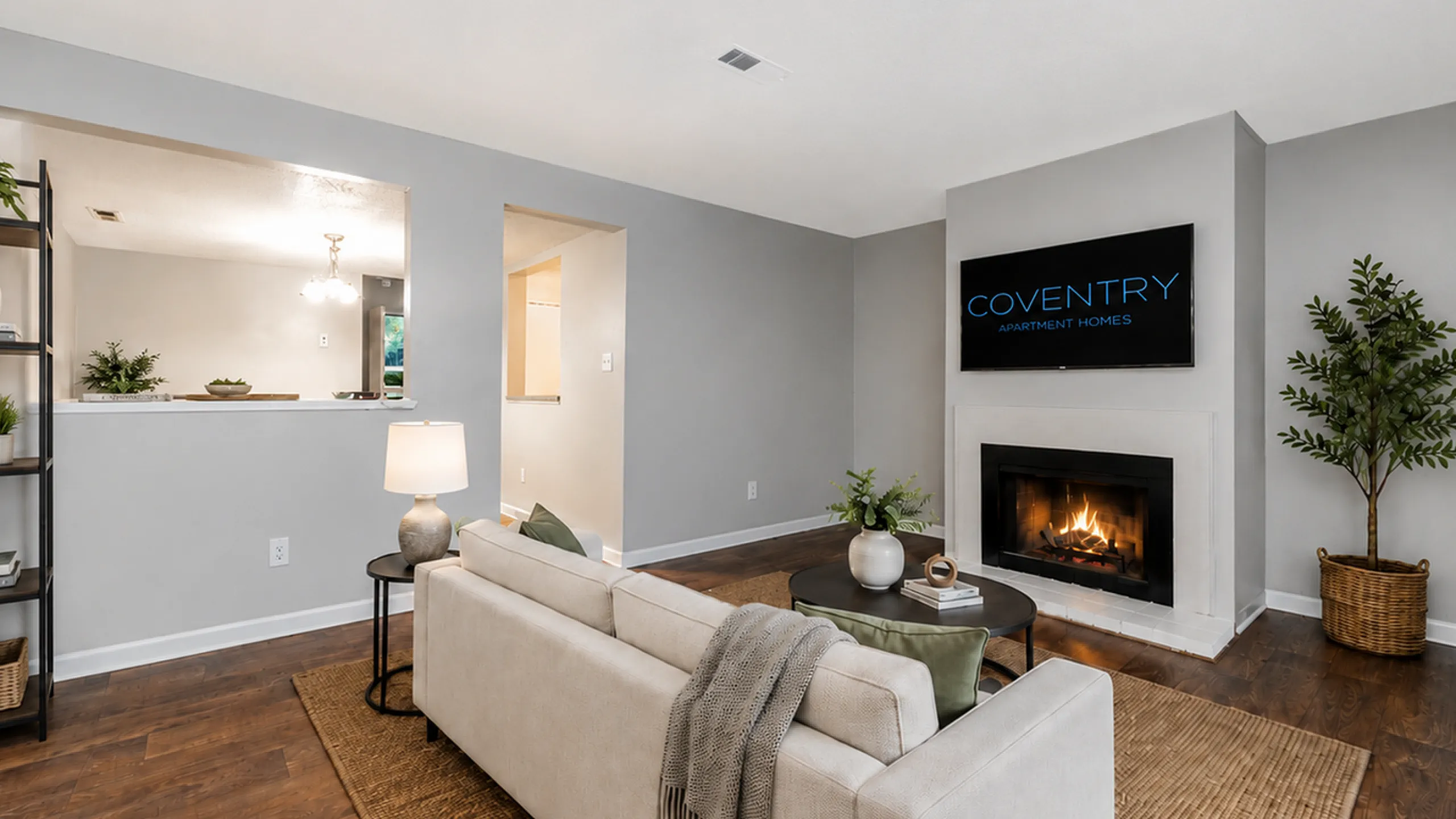 Inviting living room at Coventry Apartment Homes with cozy fireplace, elegant decor, and stylish furnishings.