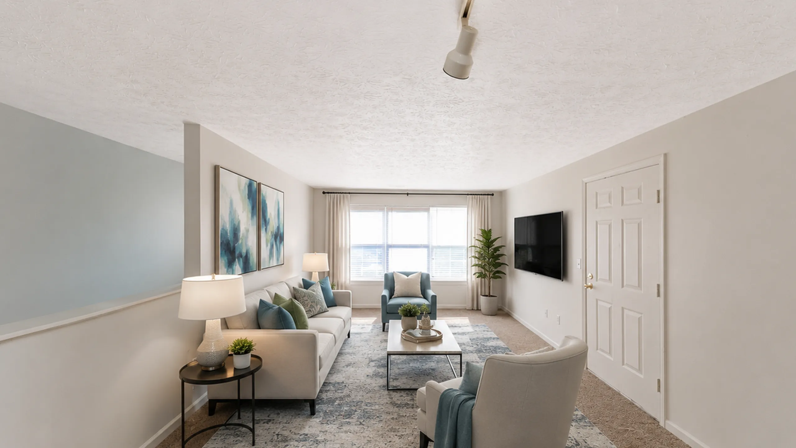 Bright and sophisticated living room with modern decor, featuring a plush sofa set, elegant artwork, and abundant natural light.