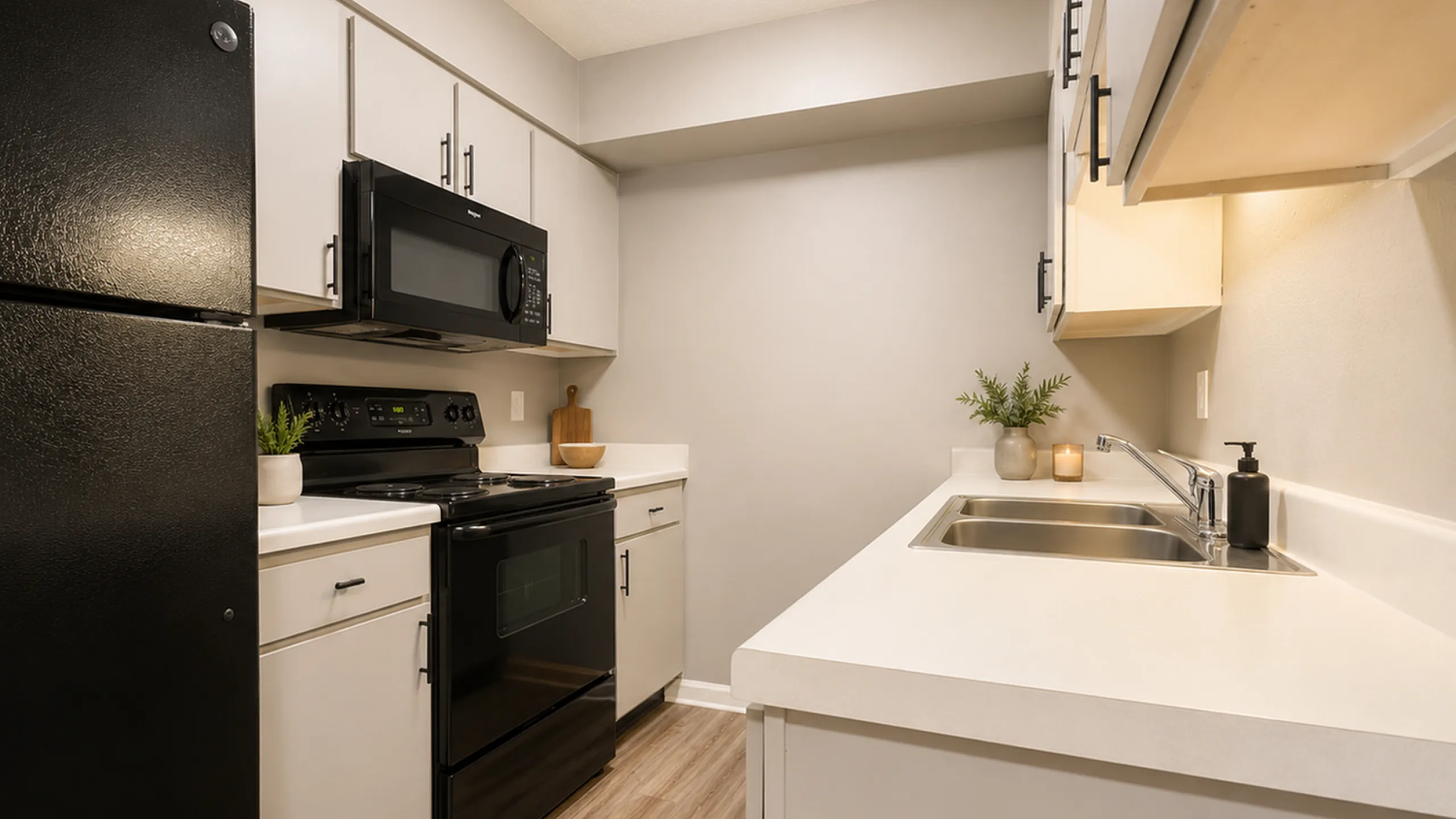 Sleek modern kitchen with stylish black appliances, elegant cabinetry, and spacious countertops.