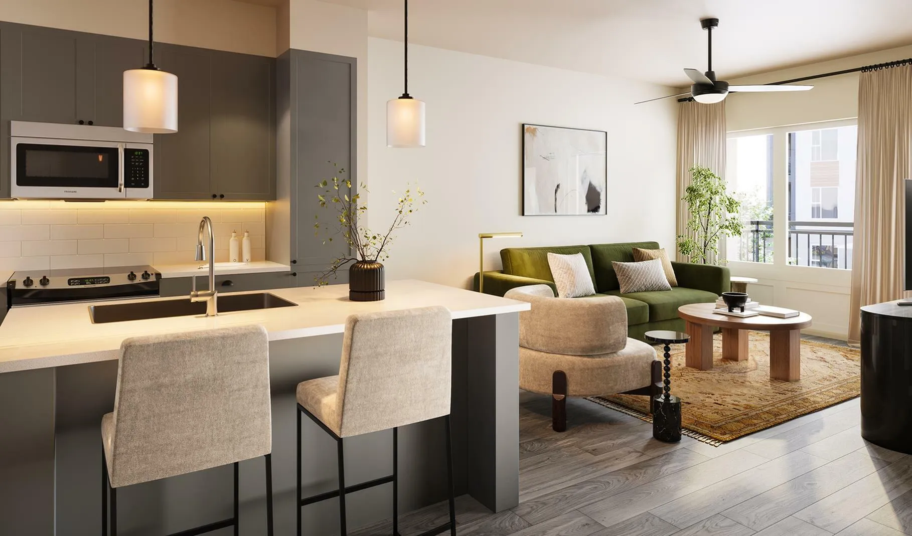 A kitchen with a kitchen island countertop with views of a living room at The Hickory at Indian Lake Village apartments for rent in Hendersonville, Tennessee.