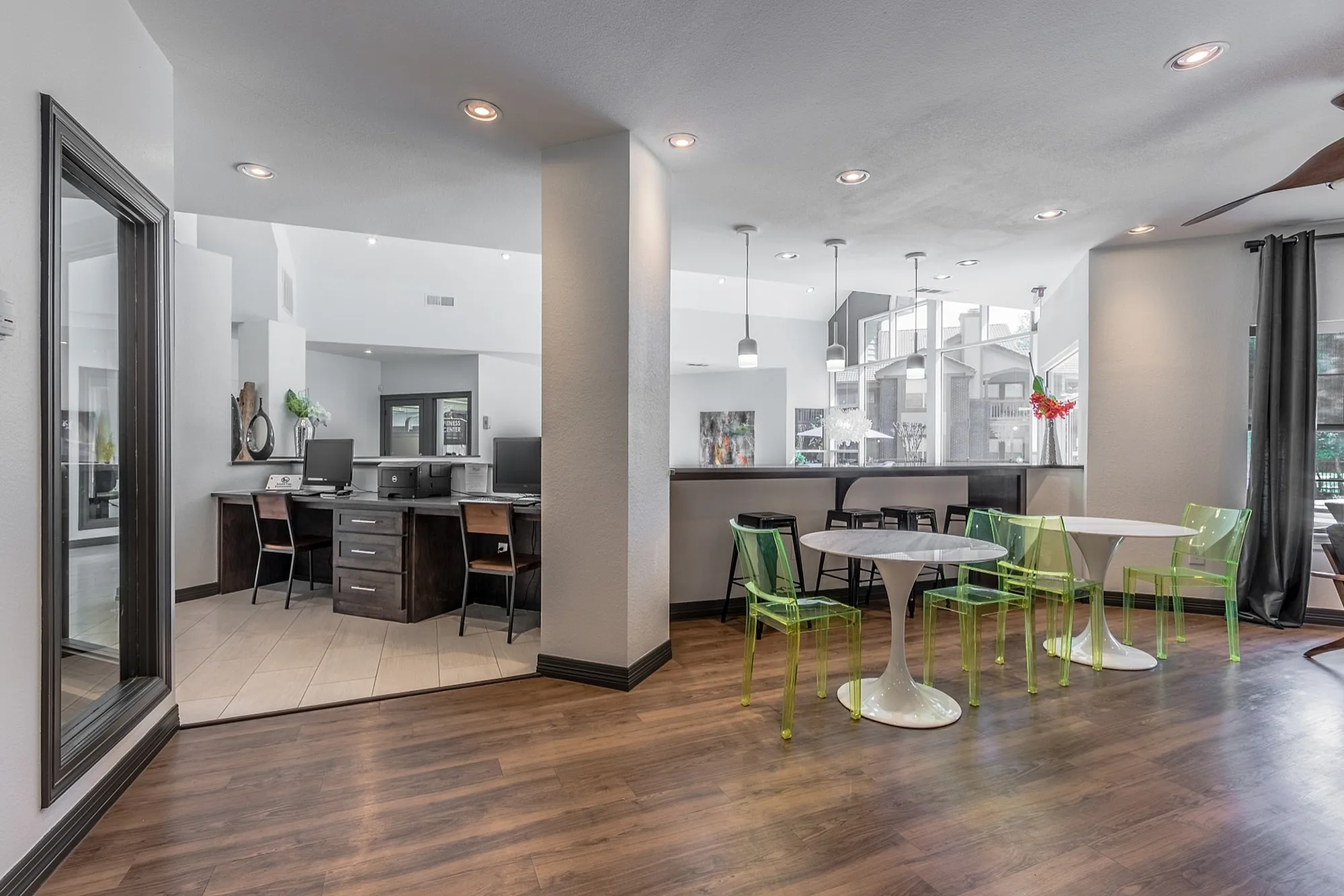 Sophisticated open-concept lounge with stylish seating, modern decor, and abundant natural light through large windows.