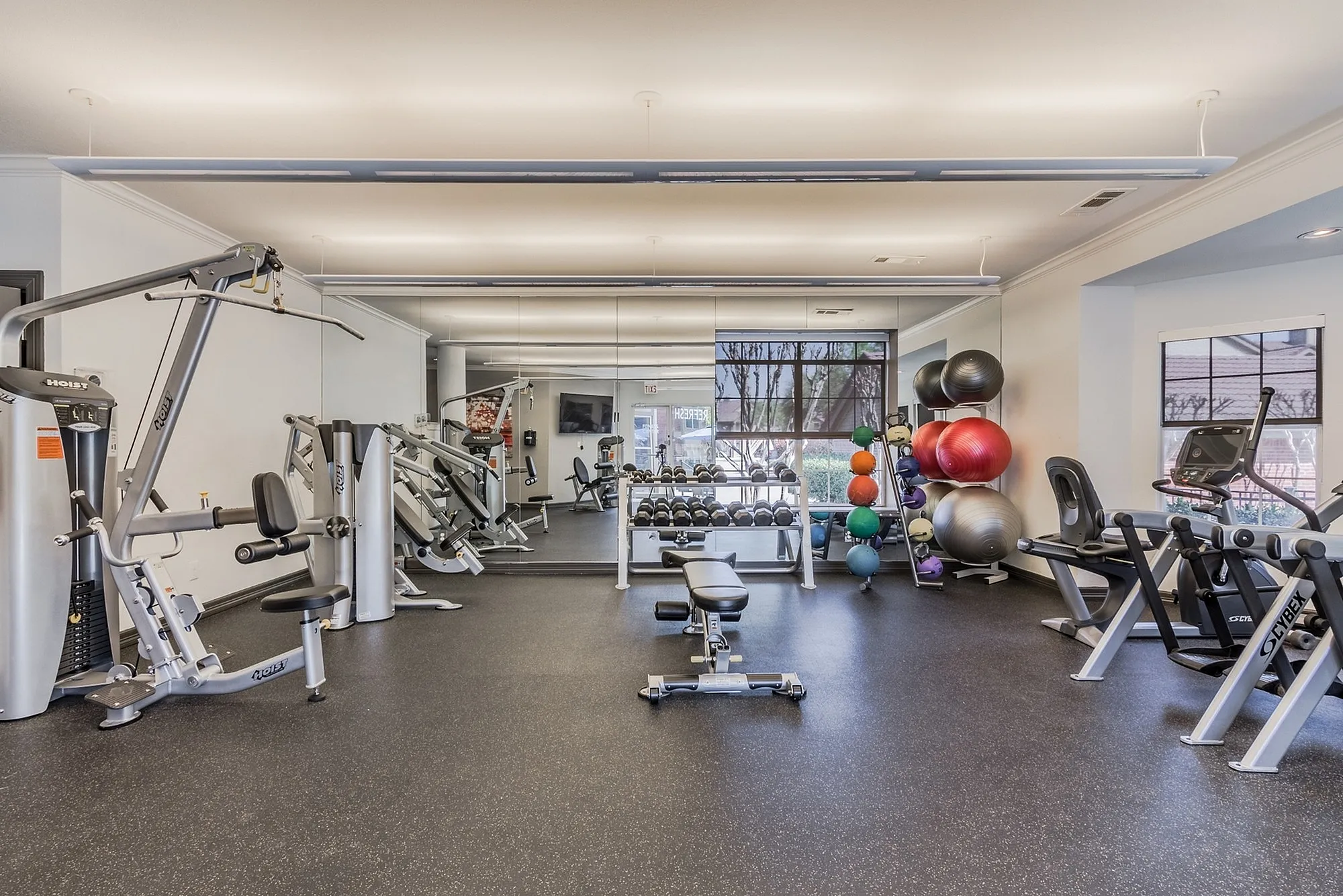 Modern gym with state-of-the-art equipment and vibrant exercise balls, perfect for a health-focused lifestyle.