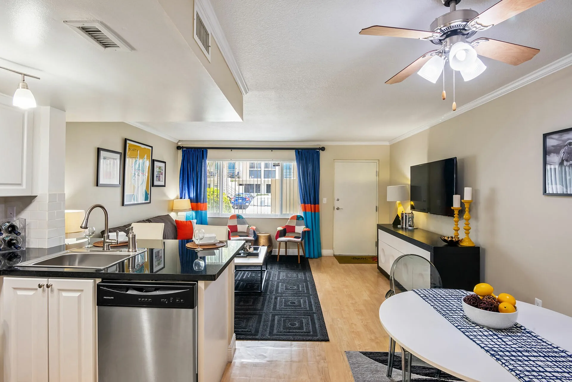 Contemporary living space with an open-concept kitchen, stylish seating, and vibrant decor, perfect for modern living.
