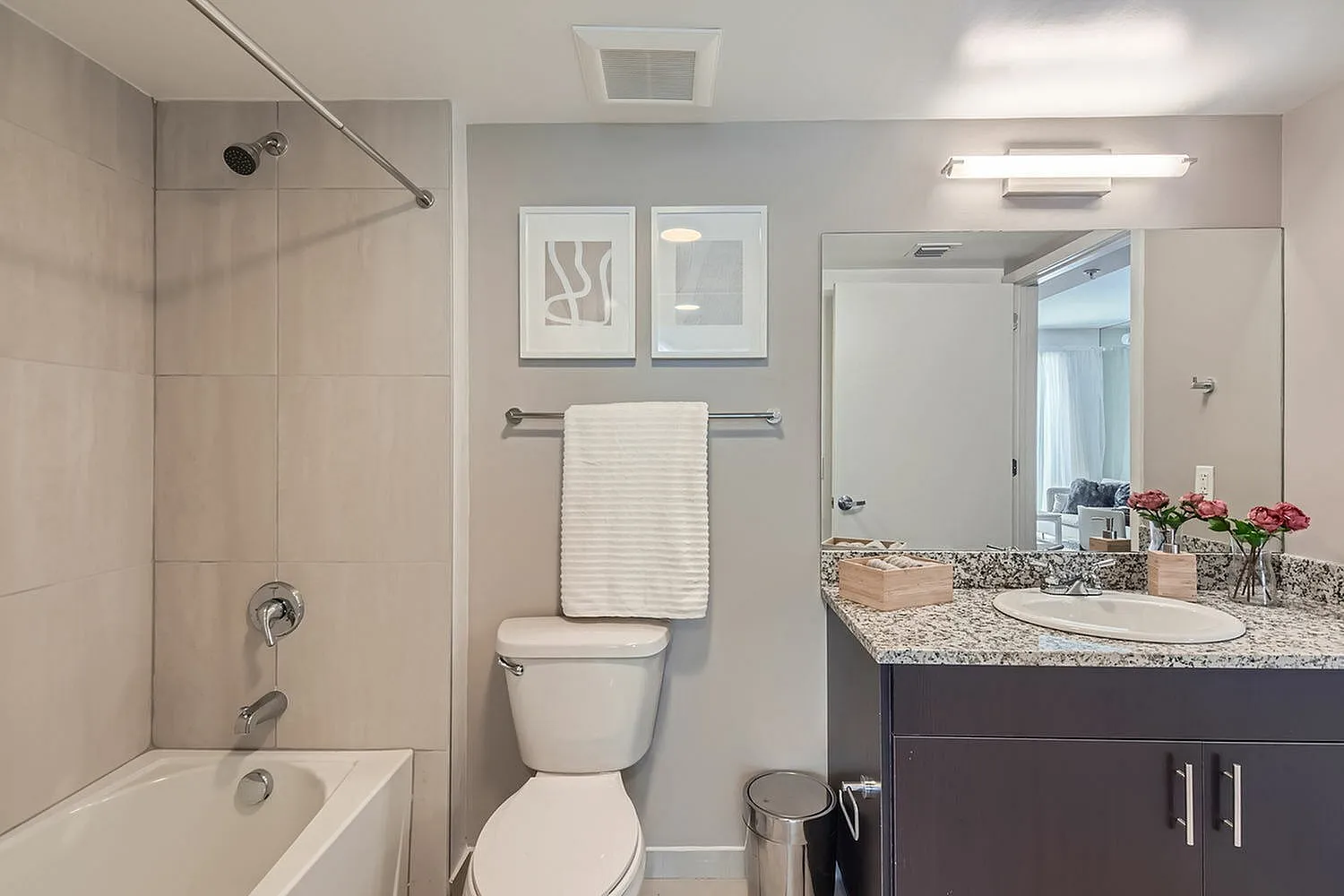 Modern bathroom with elegant granite countertop, stylish fixtures, and soothing decor, offering a tranquil retreat.