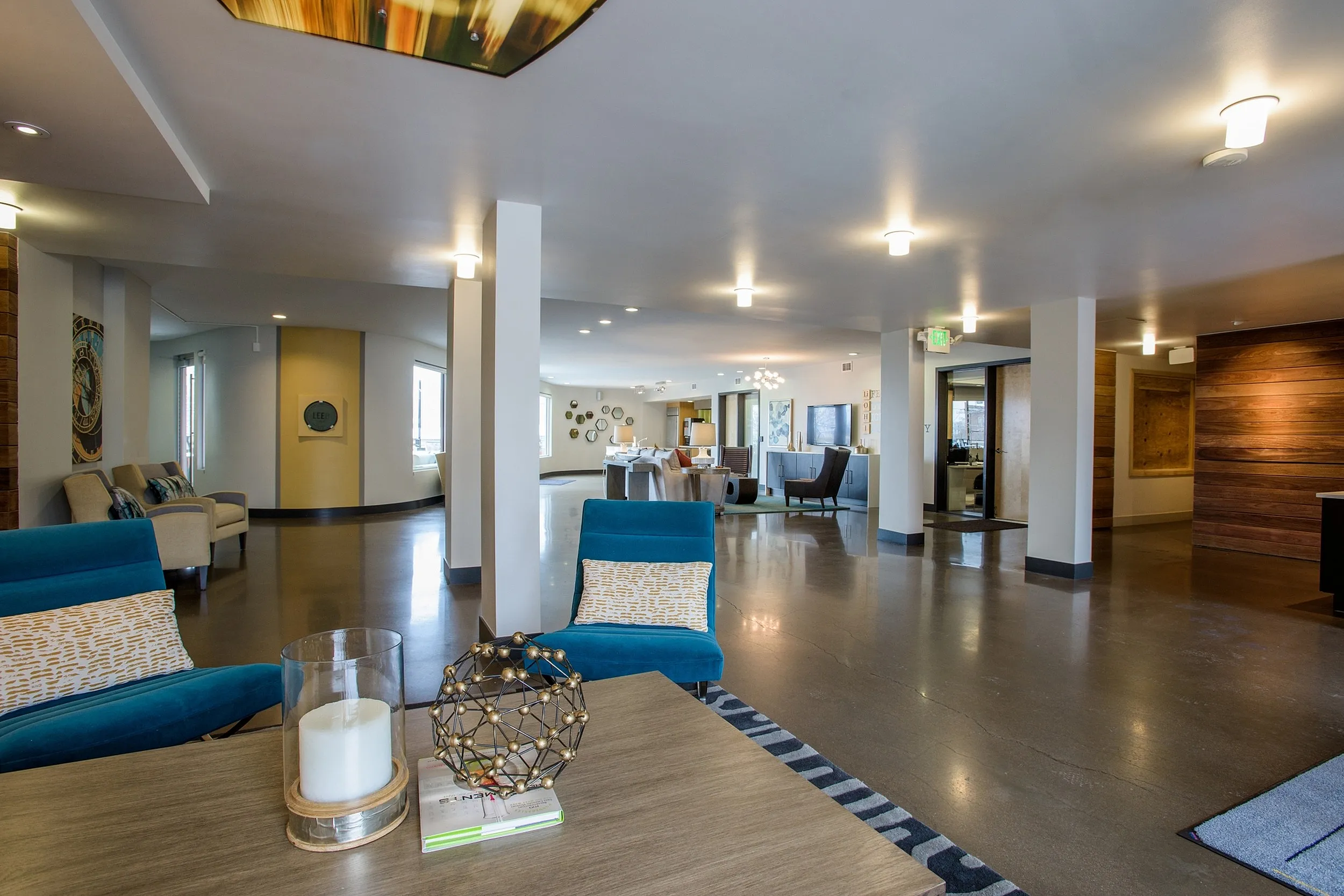 Luxurious and spacious apartment lobby showcasing modern seating, warm lighting, and stylish decor for a welcoming atmosphere.