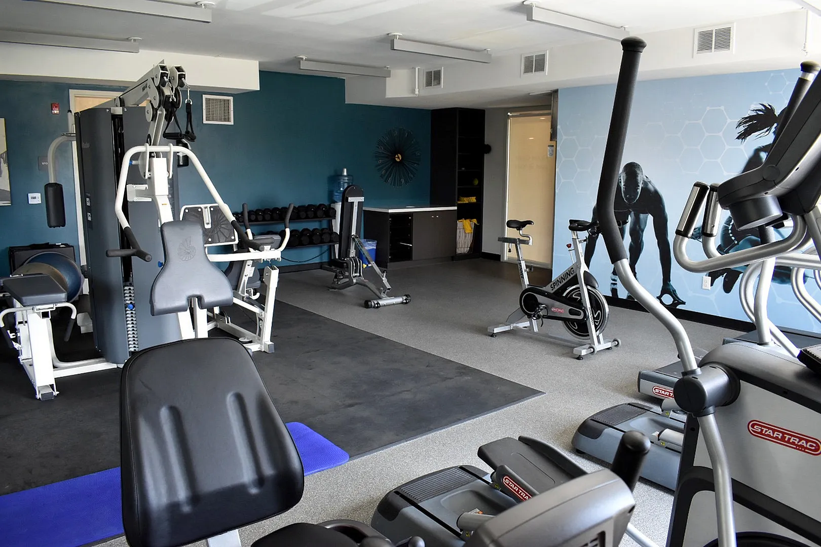 Modern fitness center with state-of-the-art gym equipment, including exercise bikes and weight machines in a bright, inviting space.