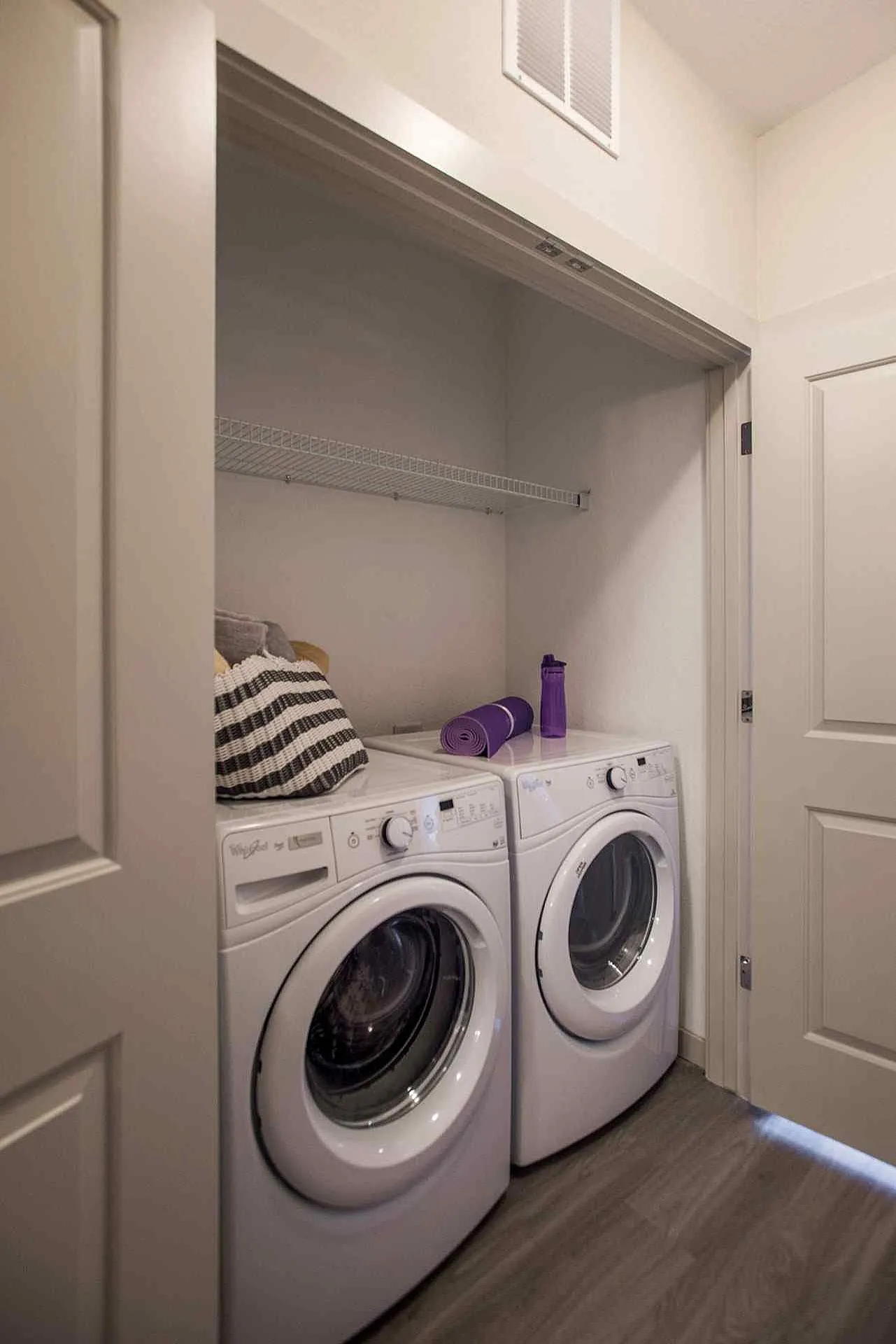Modern laundry nook with energy-efficient washer and dryer seamlessly integrated into a cozy apartment space.