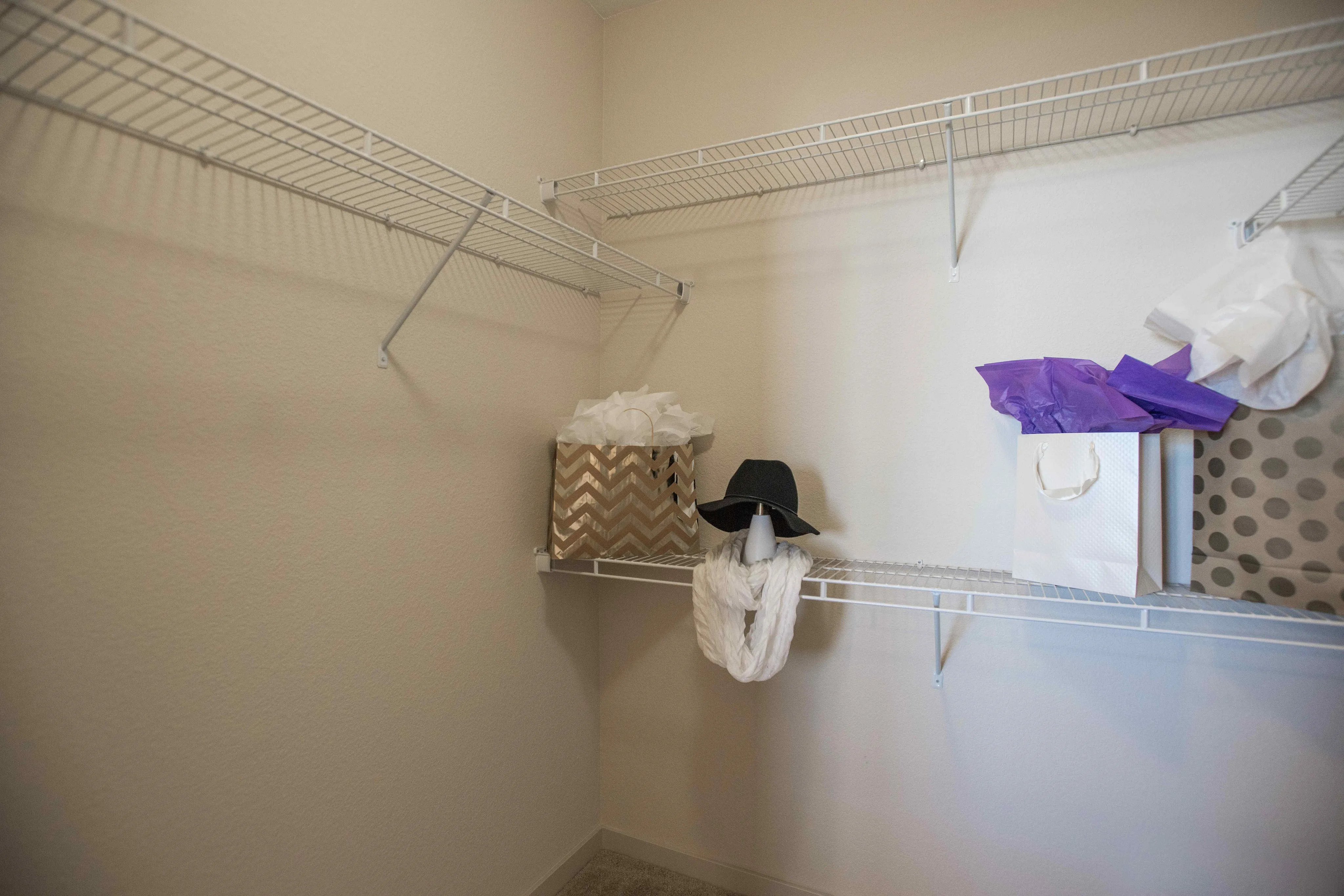 Spacious walk-in closet with organized shelving, perfect for storage and maximizing space.