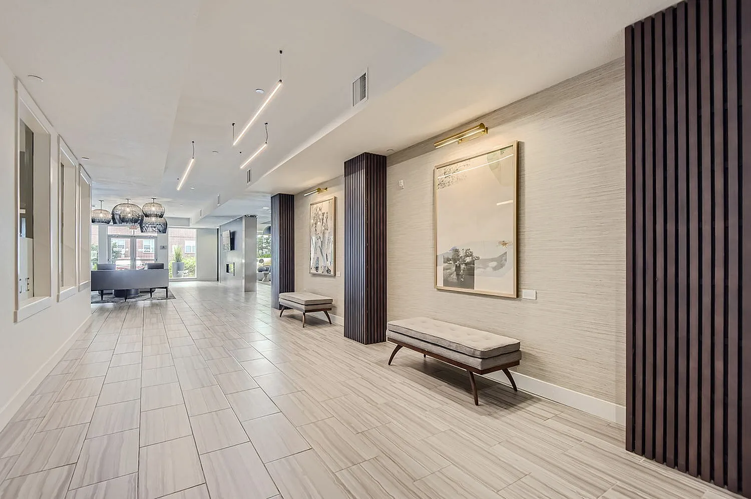 Luxurious apartment lobby with modern lighting, elegant decor, and sleek flooring, offering a sophisticated ambiance.