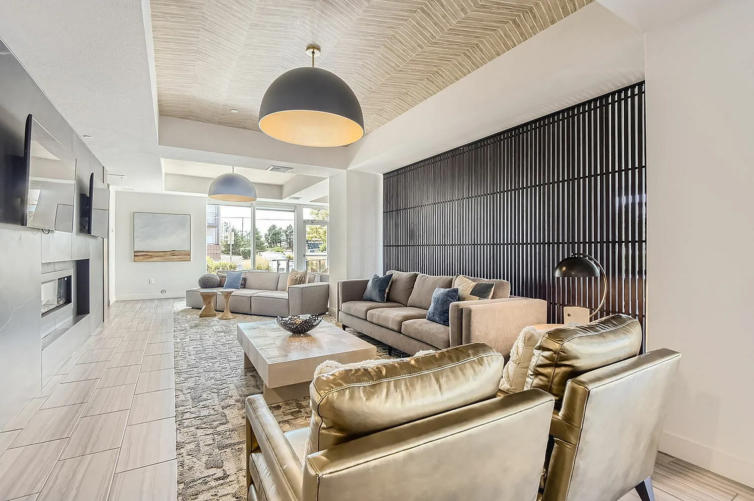 Elegant living room showcasing modern decor with plush sofas, chic lighting, and a cozy fireplace, ideal for relaxation and entertainment.