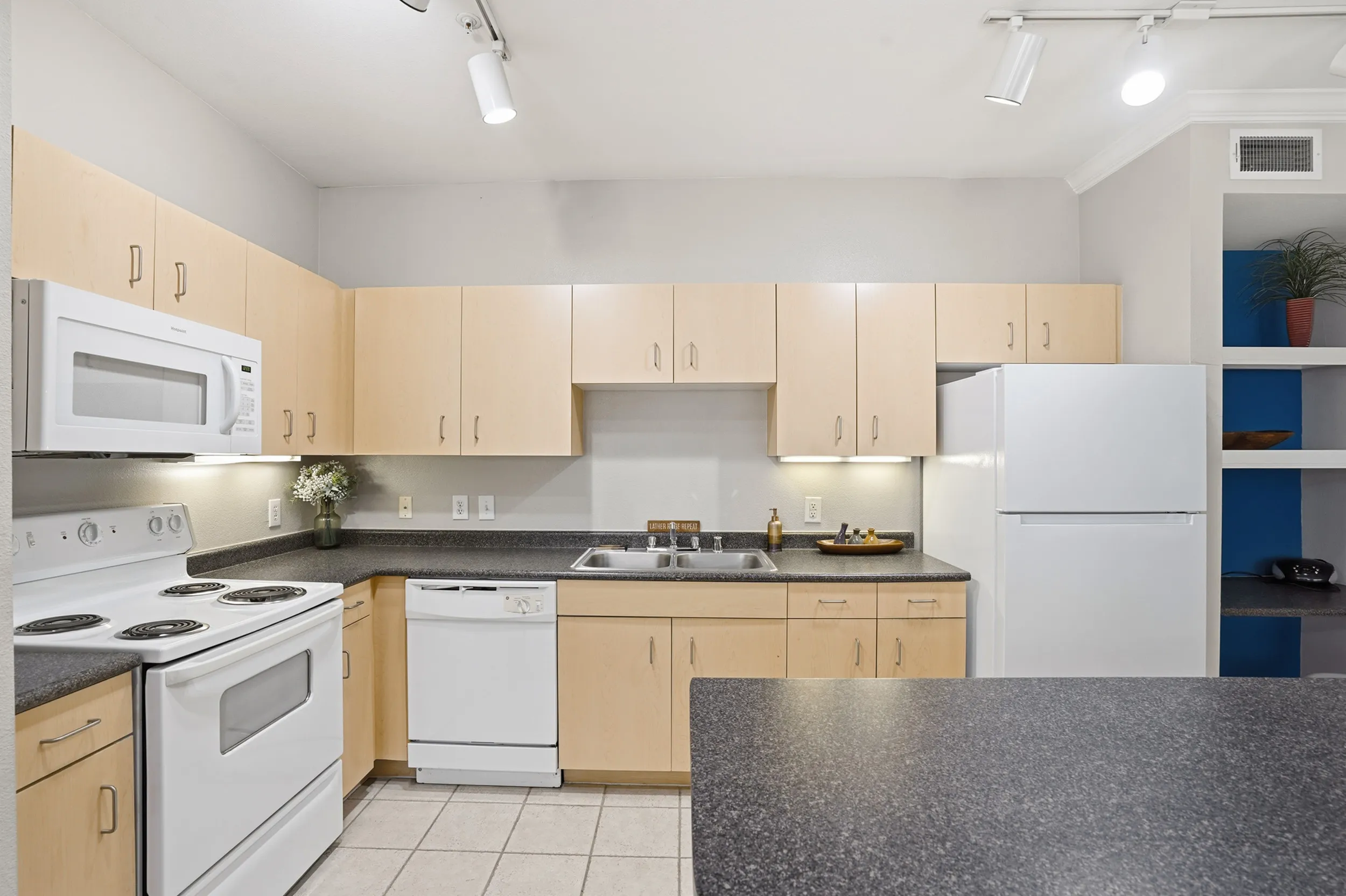 Charming kitchen with modern appliances, ample cabinet space, and elegant decor for a cozy culinary experience.