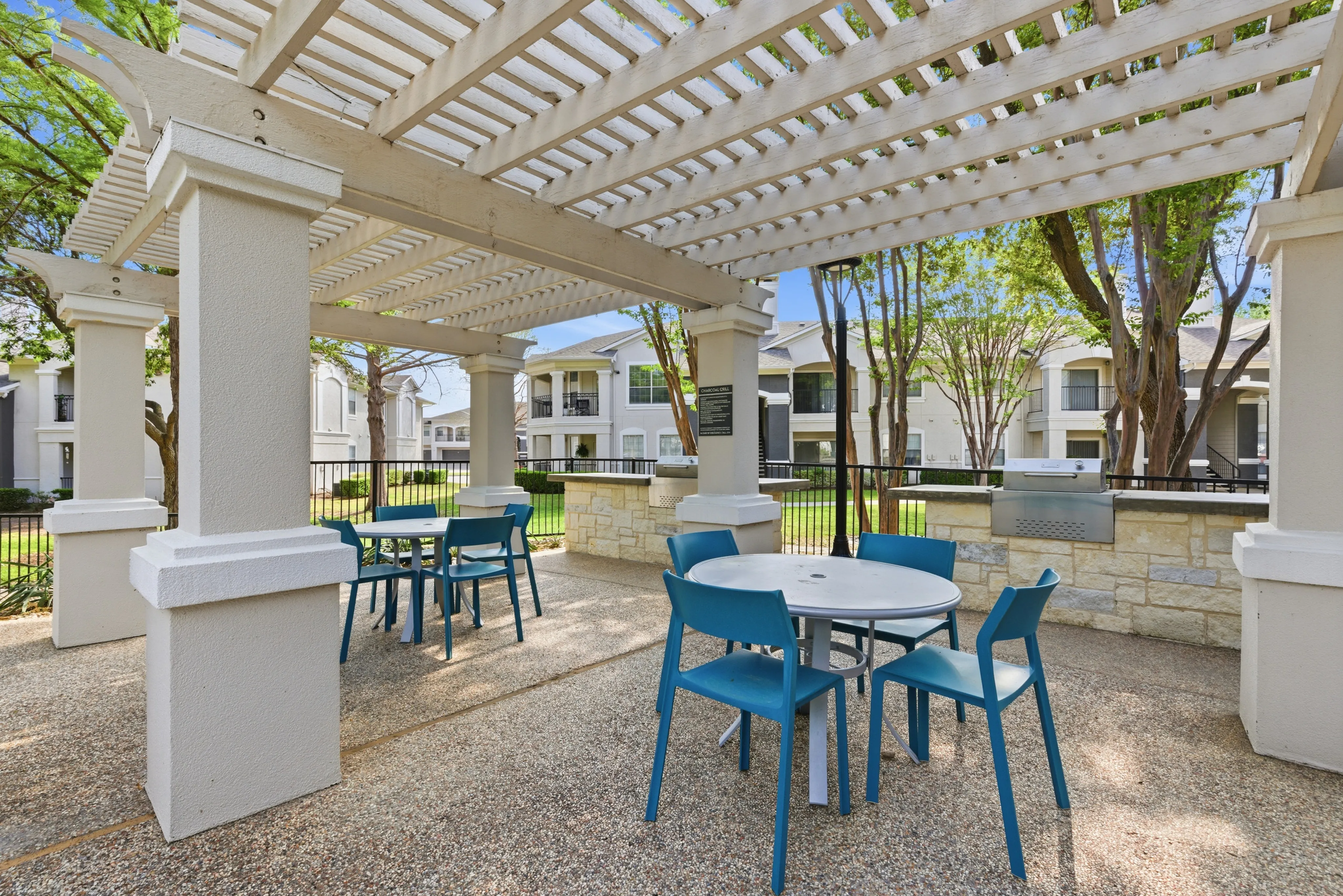 Inviting outdoor patio area with stylish pergola and chic seating, perfect for relaxation and social gatherings.
