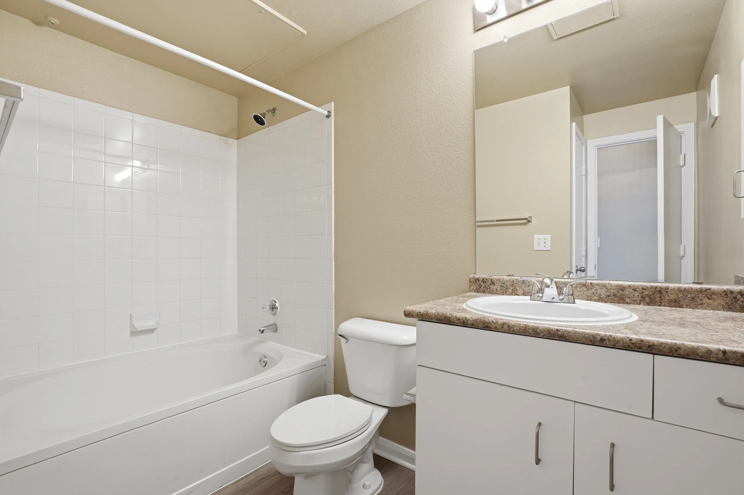 Classic bathroom with shower tub combo and sink with underneath storage