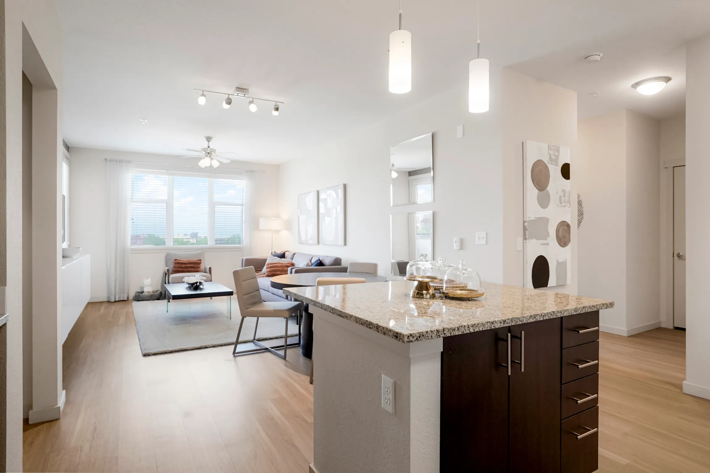 Bright and modern open-plan living room with elegant dining area, stylish decor, and ample natural light.