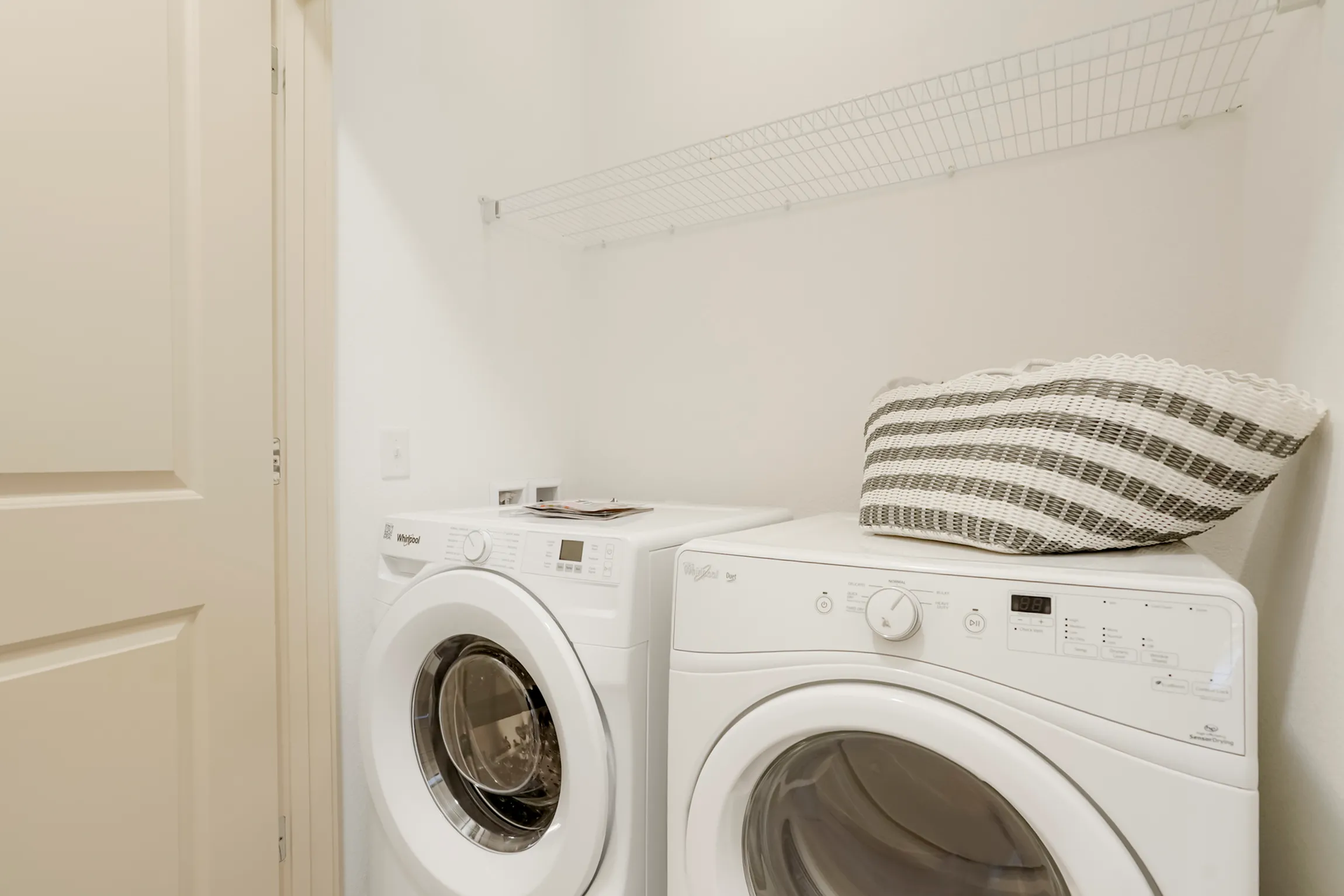 Modern laundry nook with energy-efficient washer and dryer seamlessly integrated into a cozy apartment space.