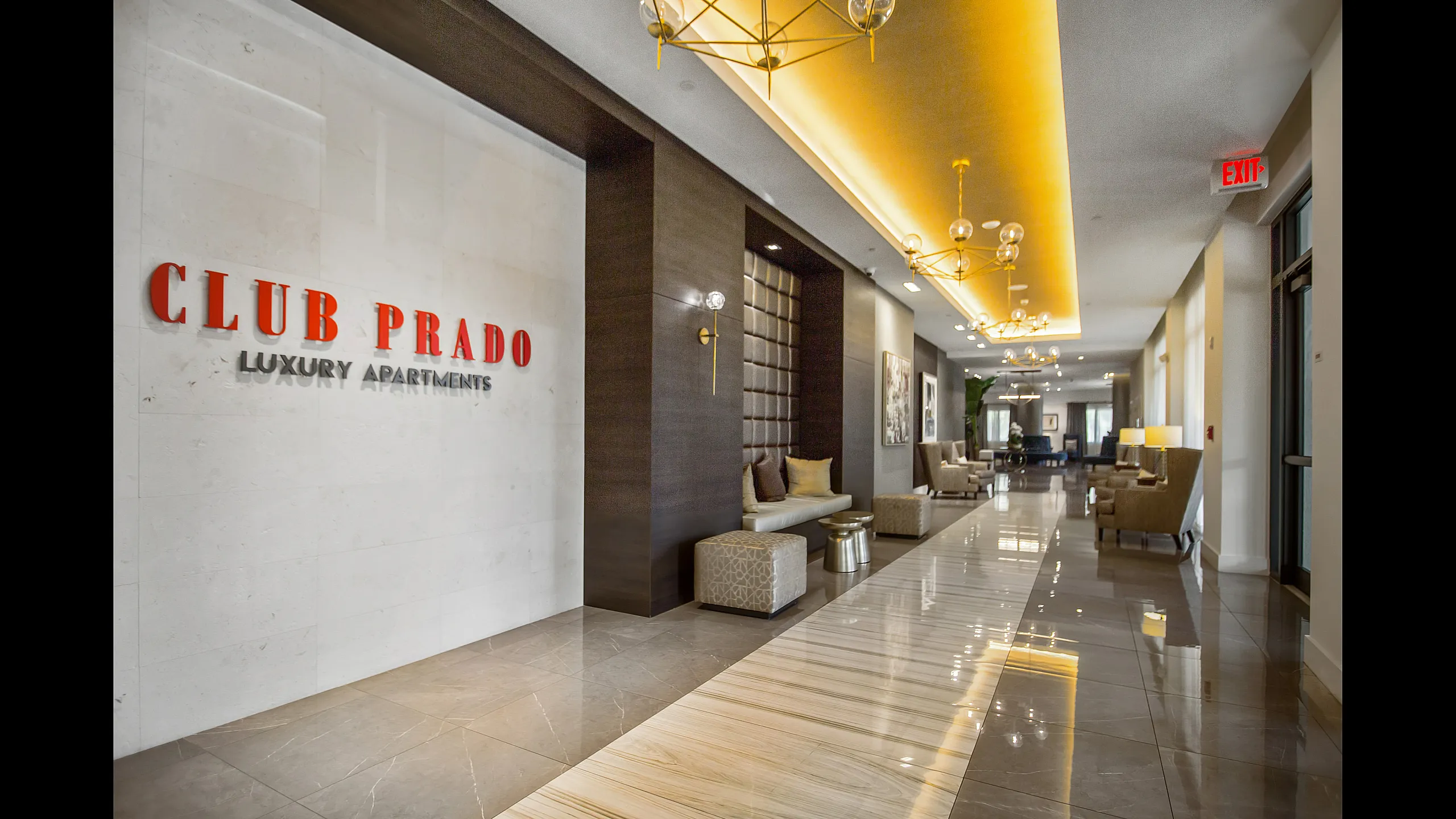 Elegant lobby of Club Prado Luxury Apartments, featuring modern decor, plush seating, and ambient lighting.