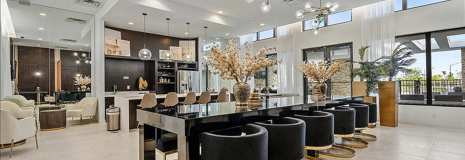 Luxurious open-plan living space with chic modern decor, featuring elegant dining area, stylish pendant lights, and floor-to-ceiling windows.