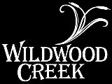 Elegant Wildwood Creek logo with artistic floral design in white.