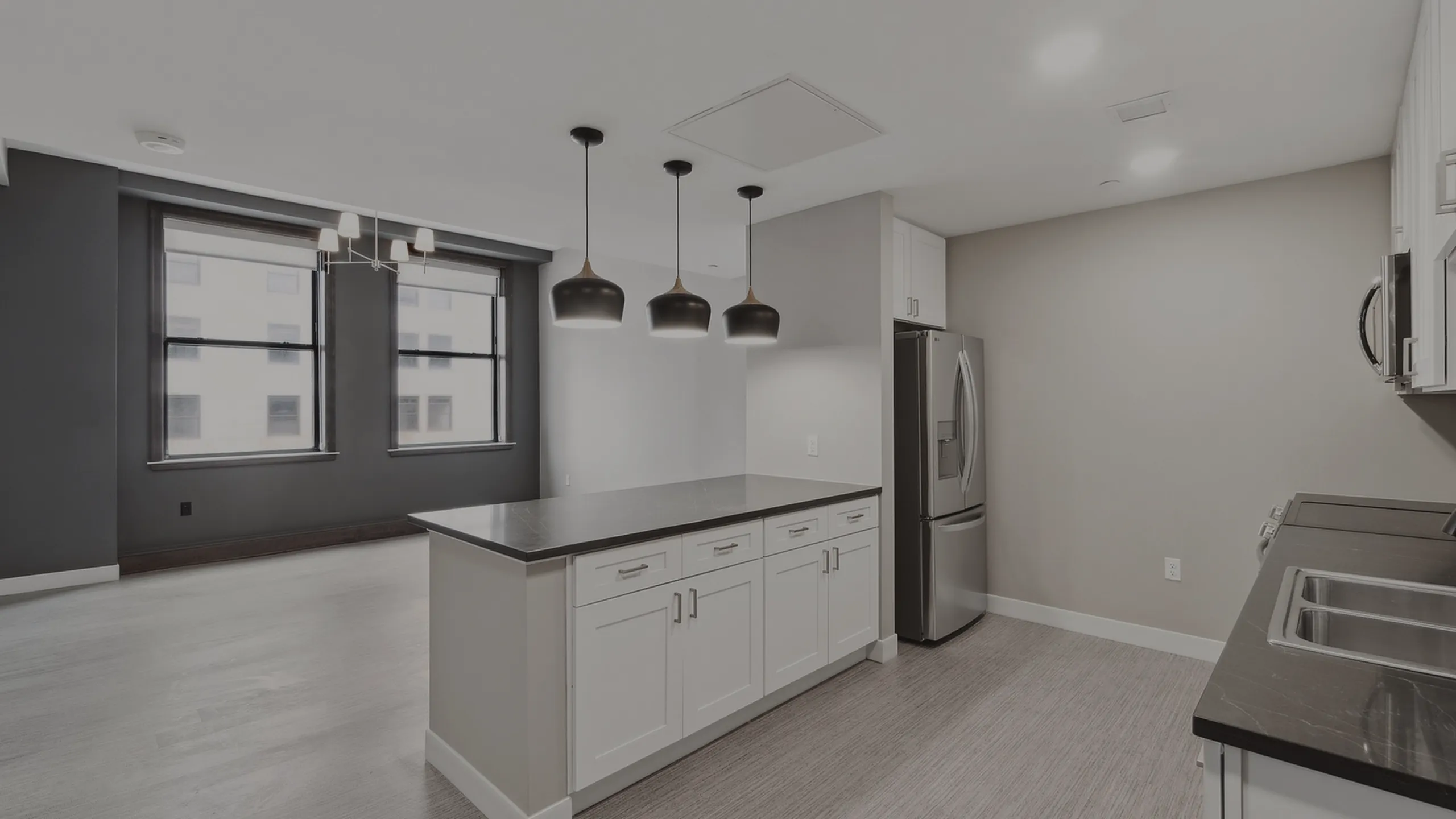 Bright, modern kitchen featuring sleek cabinetry, stainless steel appliances, and elegant pendant lighting, perfect for culinary enthusiasts.