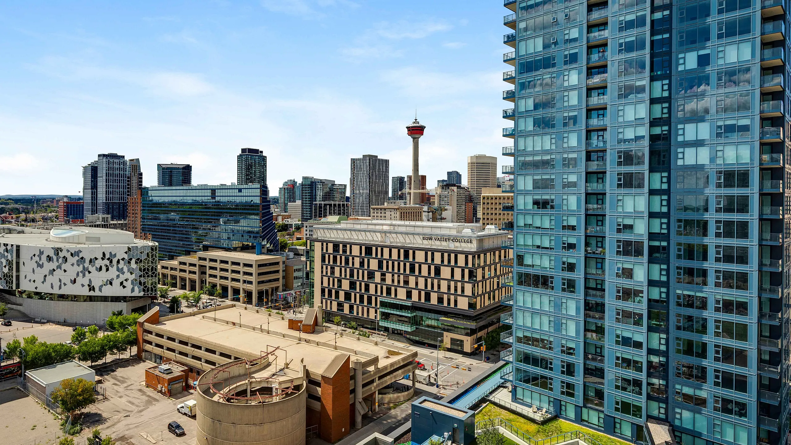 Panoramic urban vista showcasing a sleek high-rise apartment building against a vibrant cityscape, perfect for enjoying the bustling downtown lifestyle.