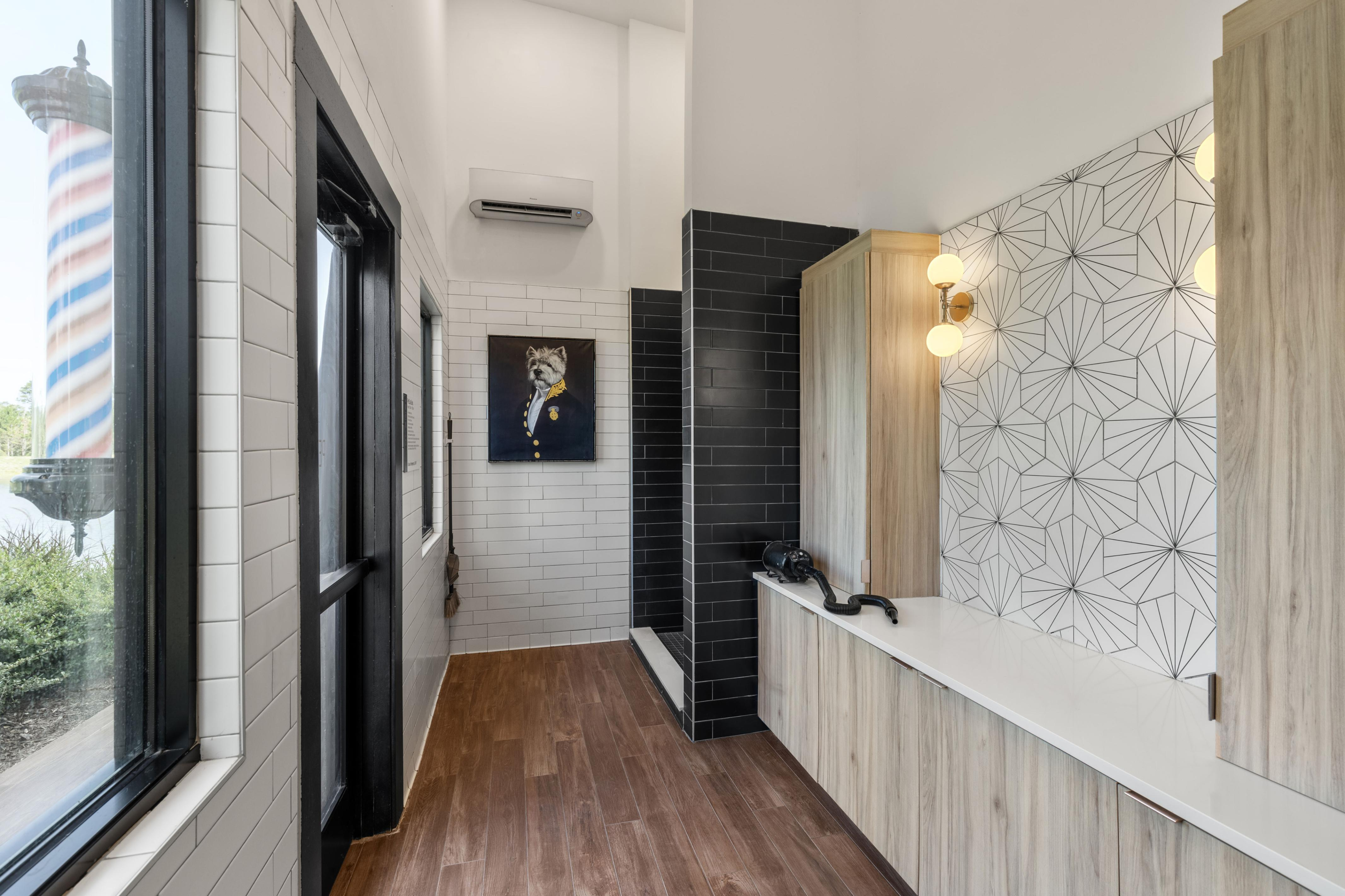 Chic modern hallway featuring elegant geometric tile design, light wood cabinets, and a stylish painting. Ideal fusion of contemporary and artistic elements.