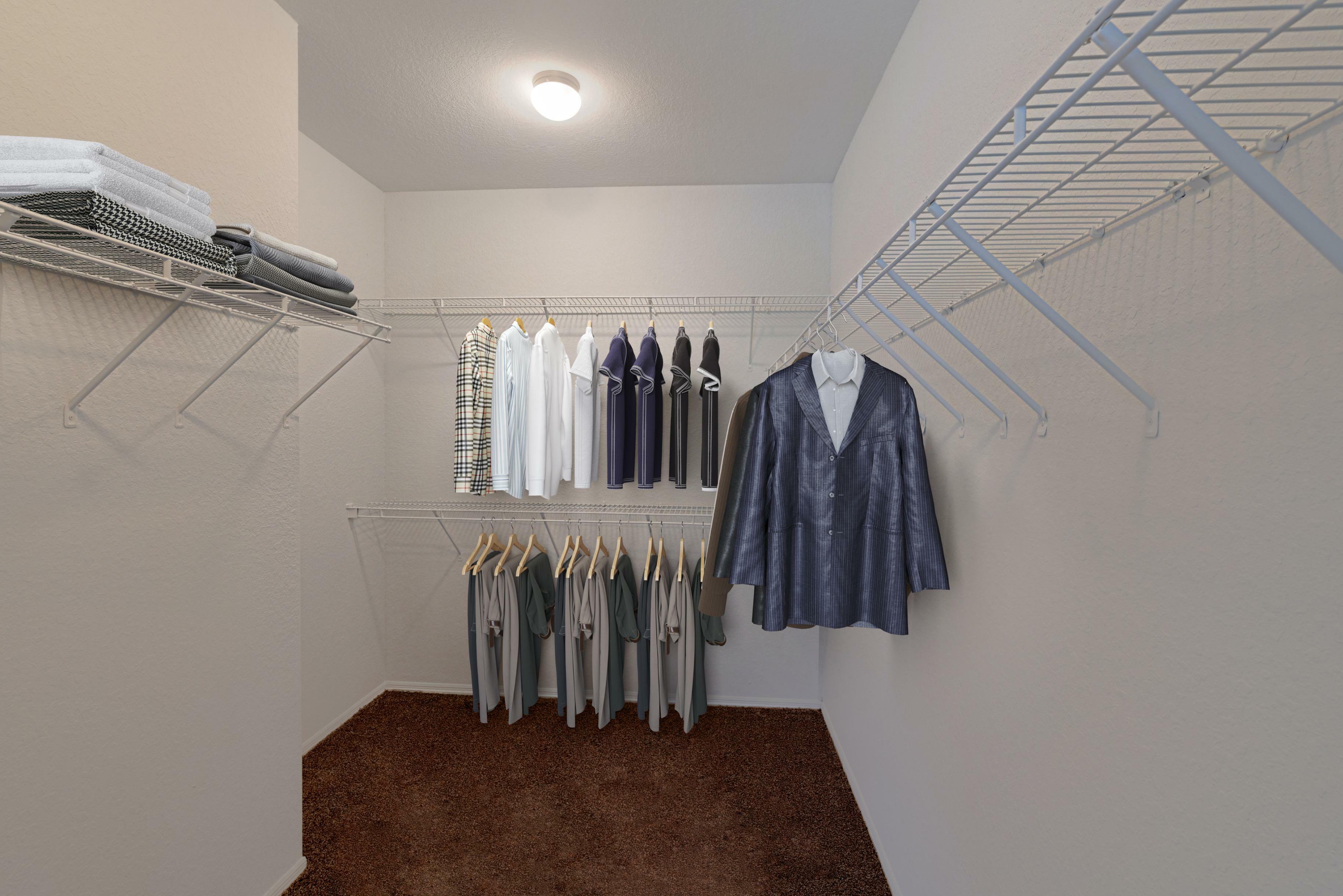 Spacious walk-in closet with organized shelving and hanging space, perfect for stylish and efficient storage.