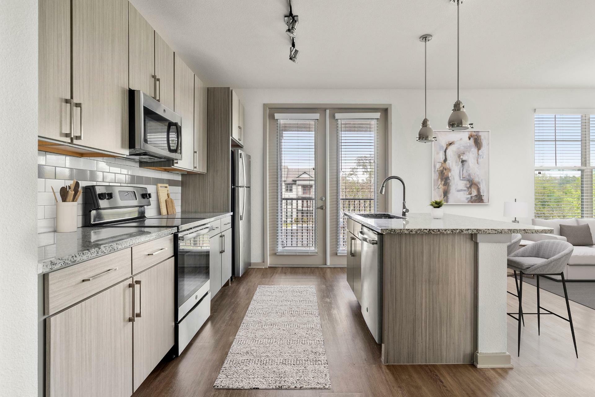 Chic modern kitchen with stainless steel appliances, granite countertops, and a cozy open-concept living area.