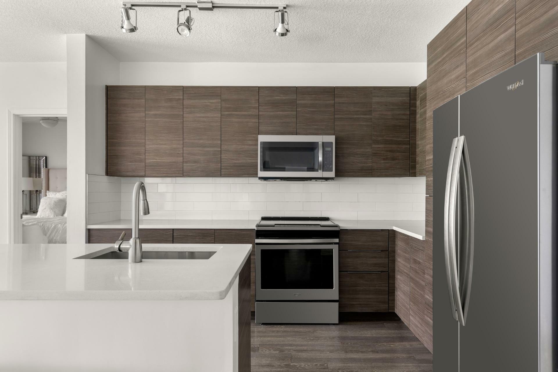 Modern kitchen with sleek cabinetry, stainless steel appliances, and elegant countertops.