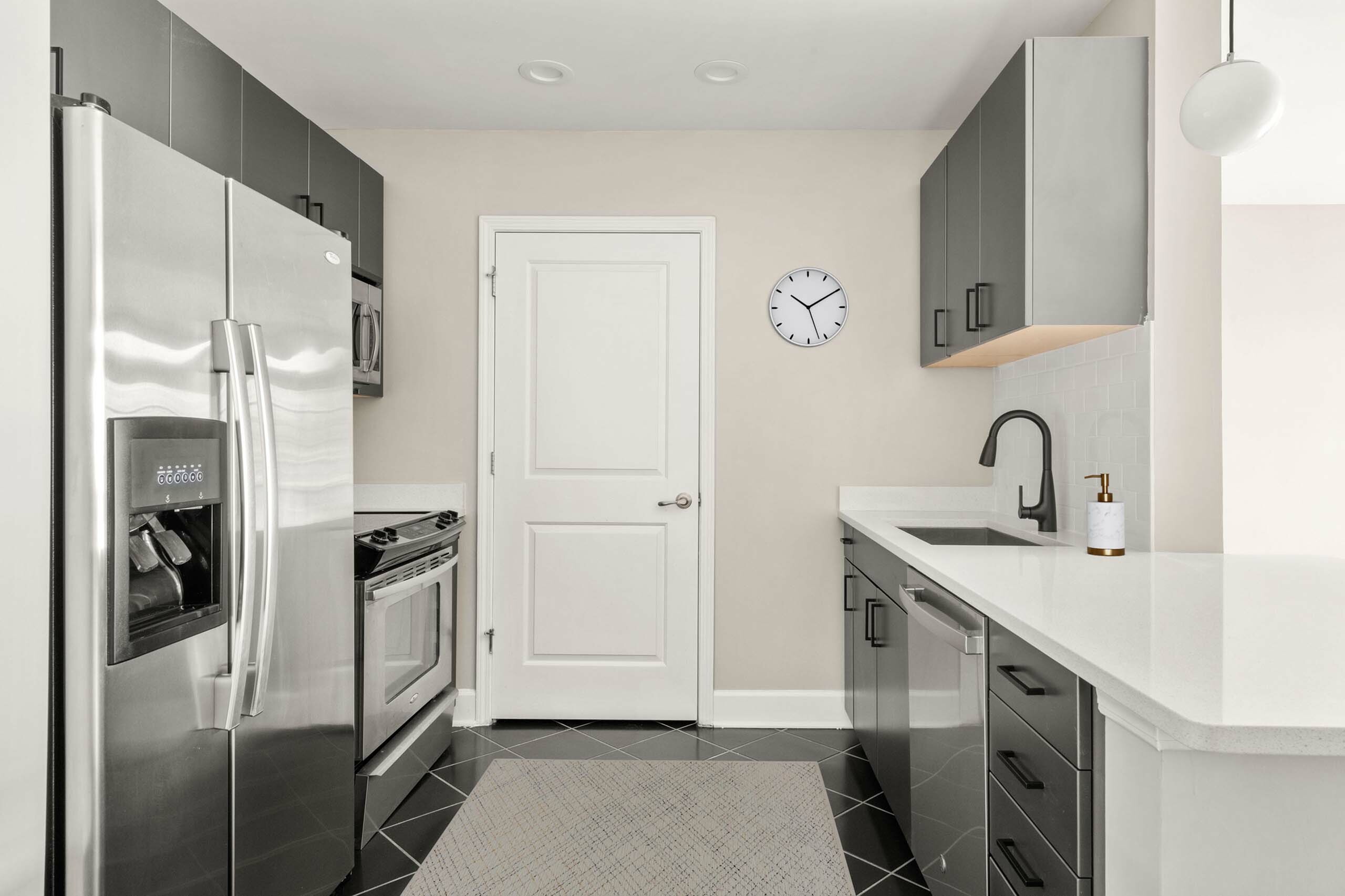 Modern kitchen with sleek stainless steel appliances, elegant cabinetry, and a stylish minimalist design.