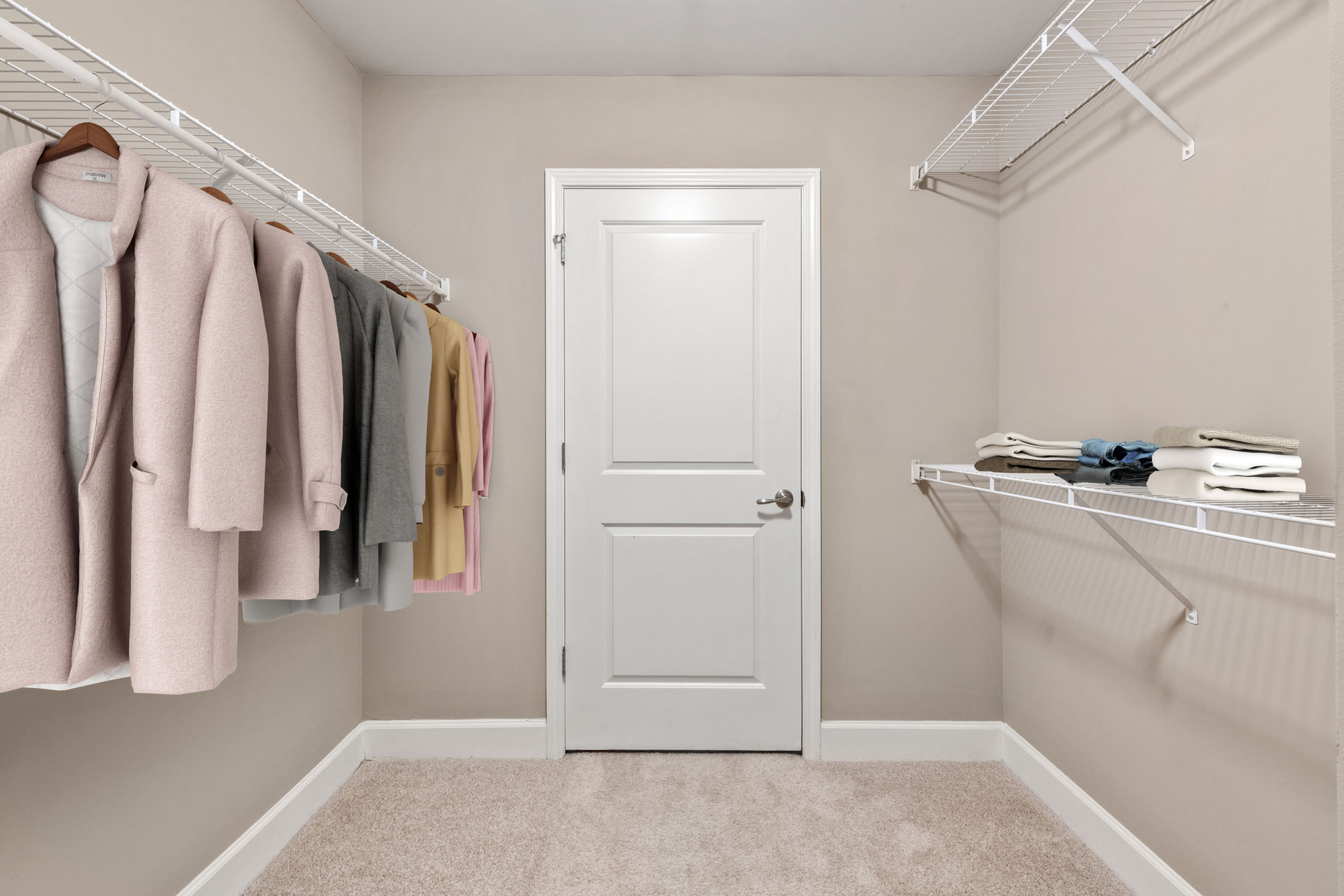 Spacious walk-in closet with elegant shelving and ample hanging space, perfect for organizing your wardrobe.