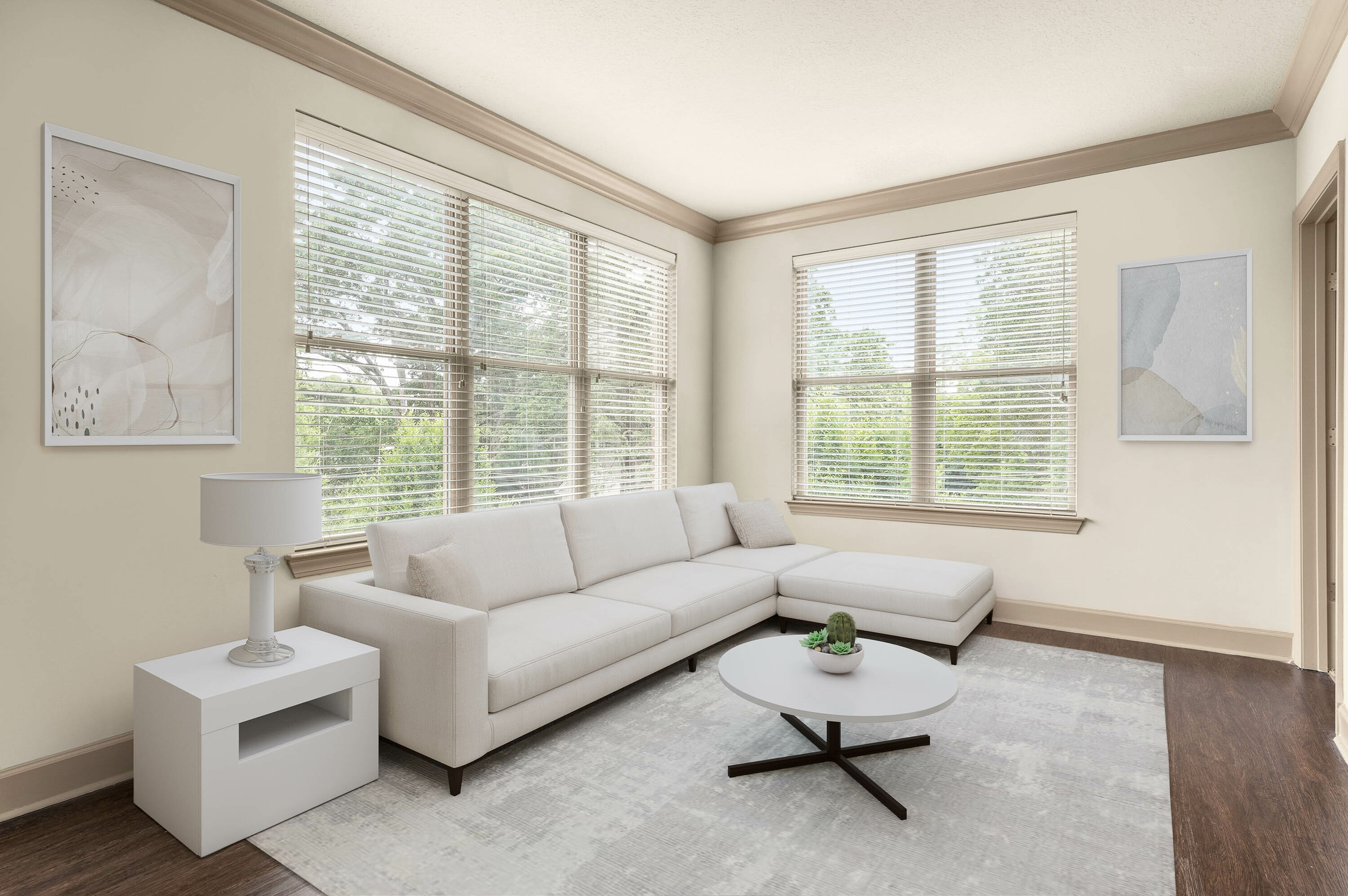 Bright and airy living room featuring a plush white sofa, modern coffee table, and large windows with tranquil garden views.