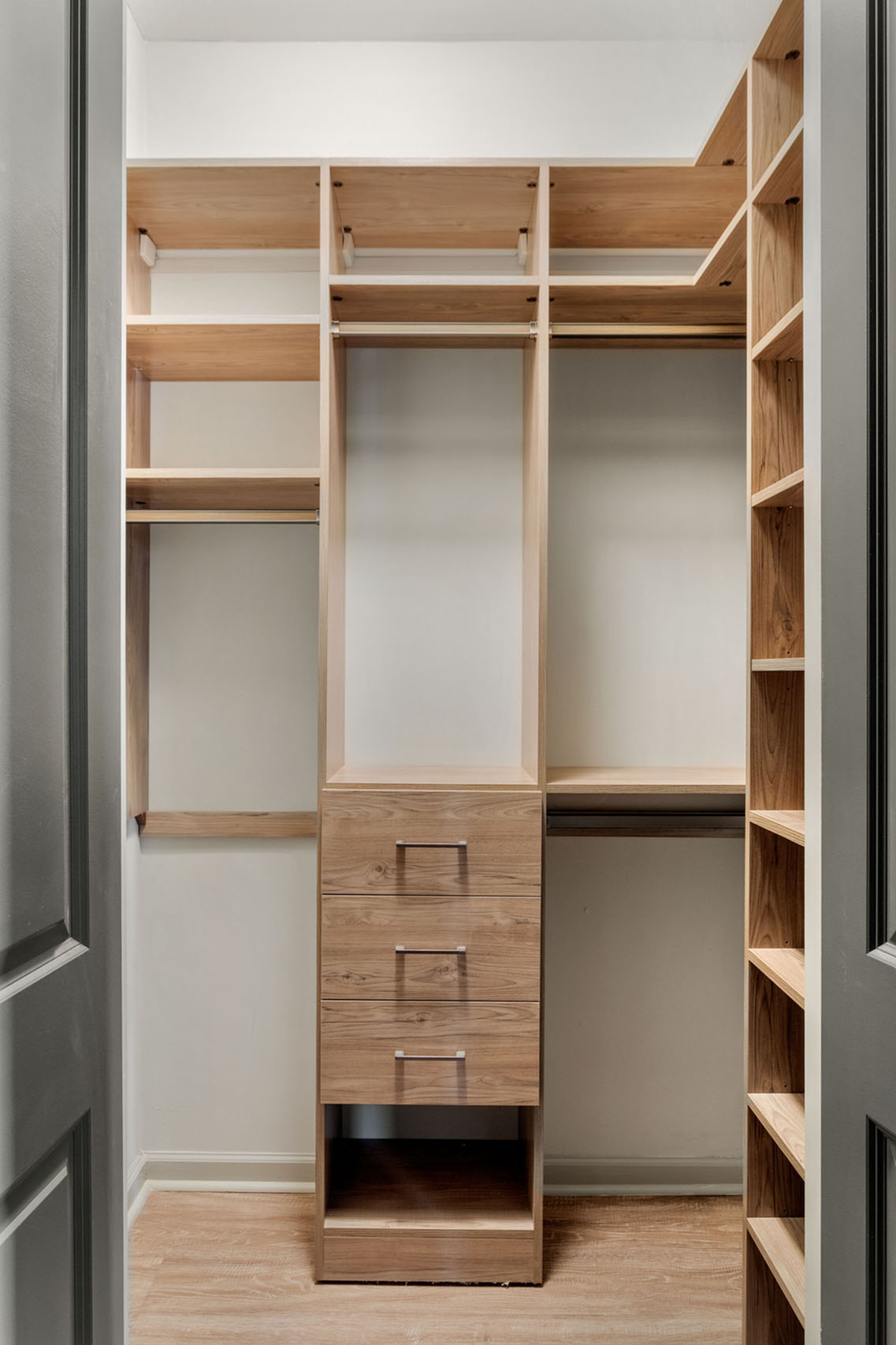 Luxurious walk-in closet with elegant wooden shelving and ample storage space.