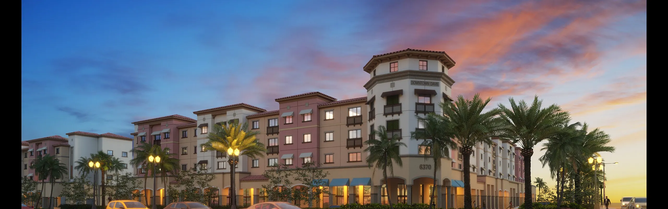 Chic apartment complex at twilight with palm trees and streetlights, offering modern urban living.
