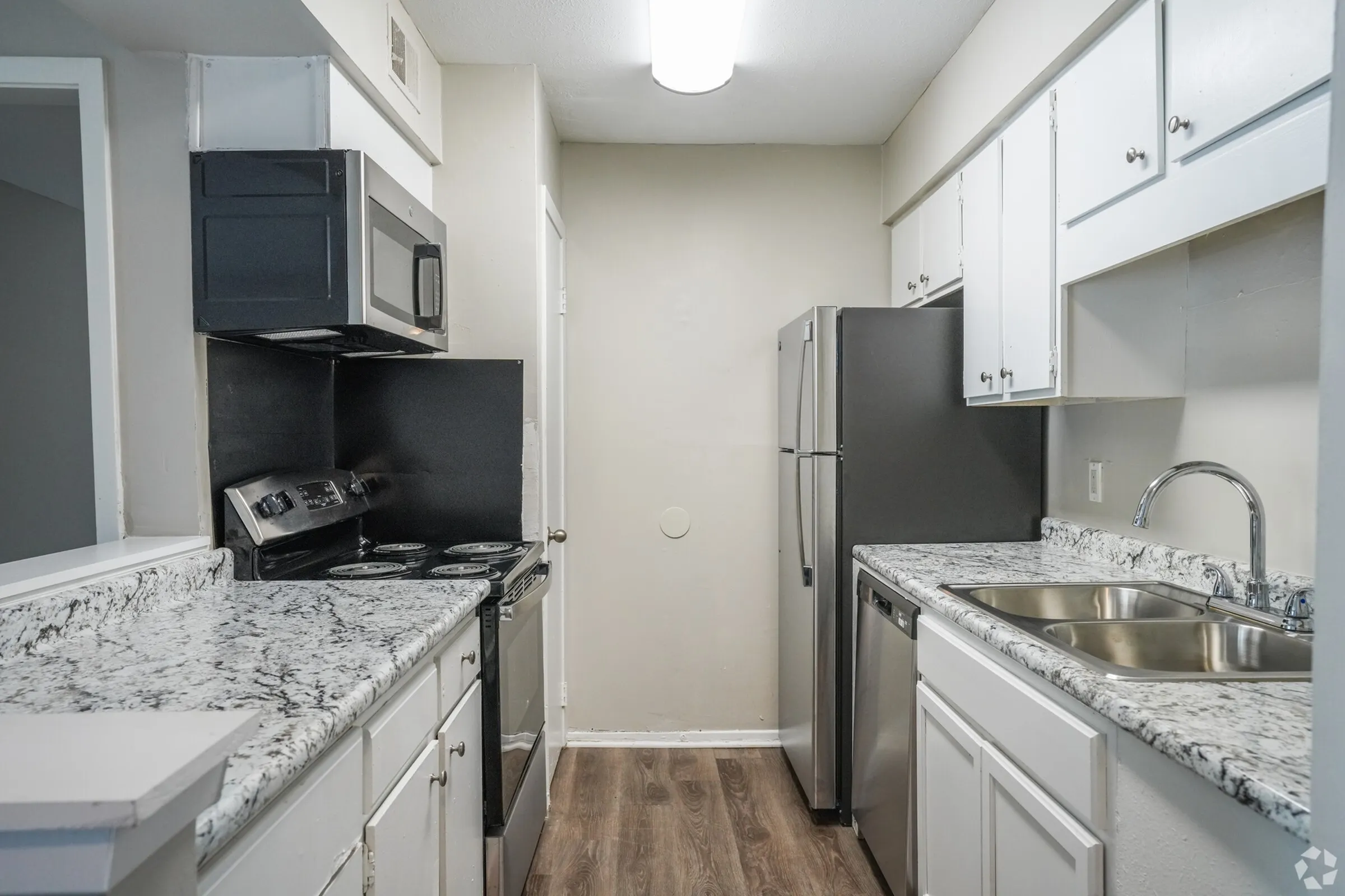 Kitchen with granite counters and black appliances in a 2 bedroom, 2 bath apartment at Trails at Northpointe in Jackson, MS