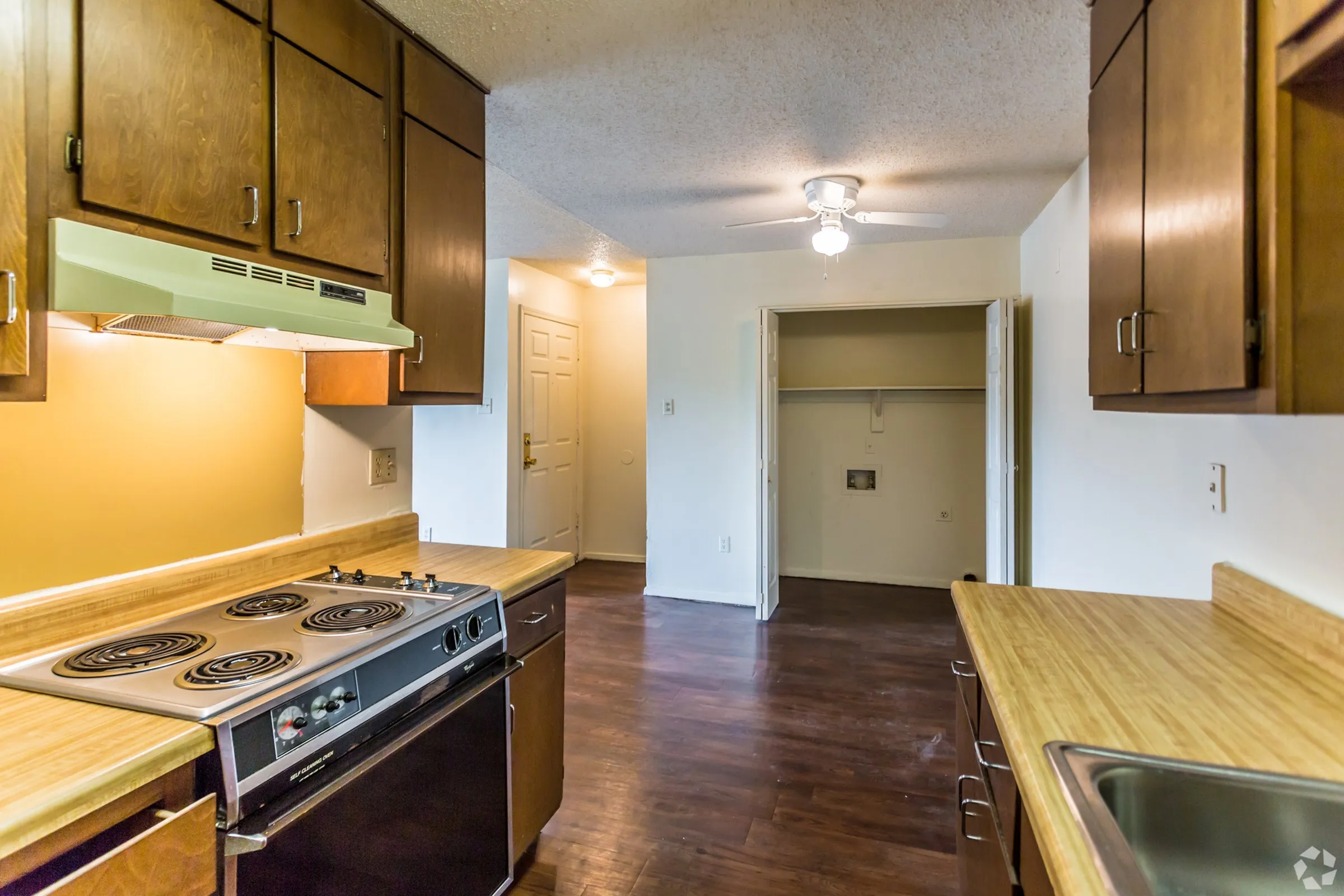 Kitchen with wood cabinets and a range hood at Hickory Pointe in Memphis, TN