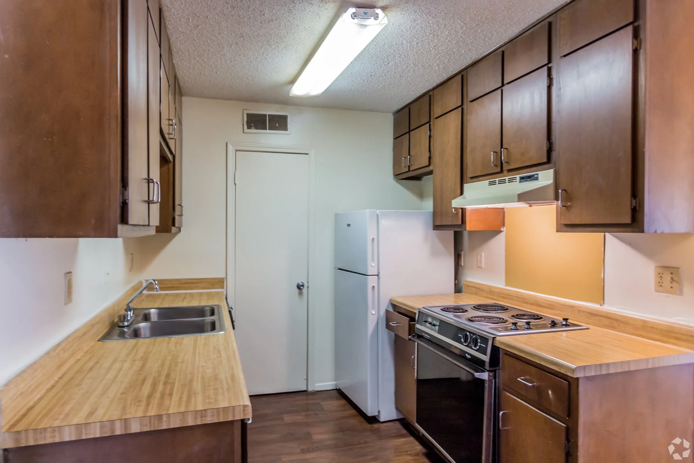 Kitchen with wood cabinets and black appliances at Hickory Pointe in Memphis, TN