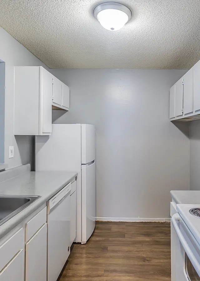Kitchen with white cabinets and electric range at Deerfield Apartments in Memphis, TN