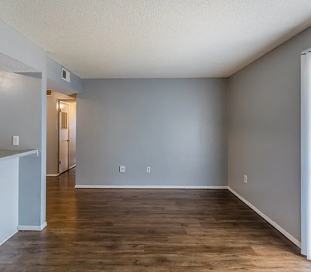 Open living room with vertical blinds at Deerfield Apartments in Memphis, TN
